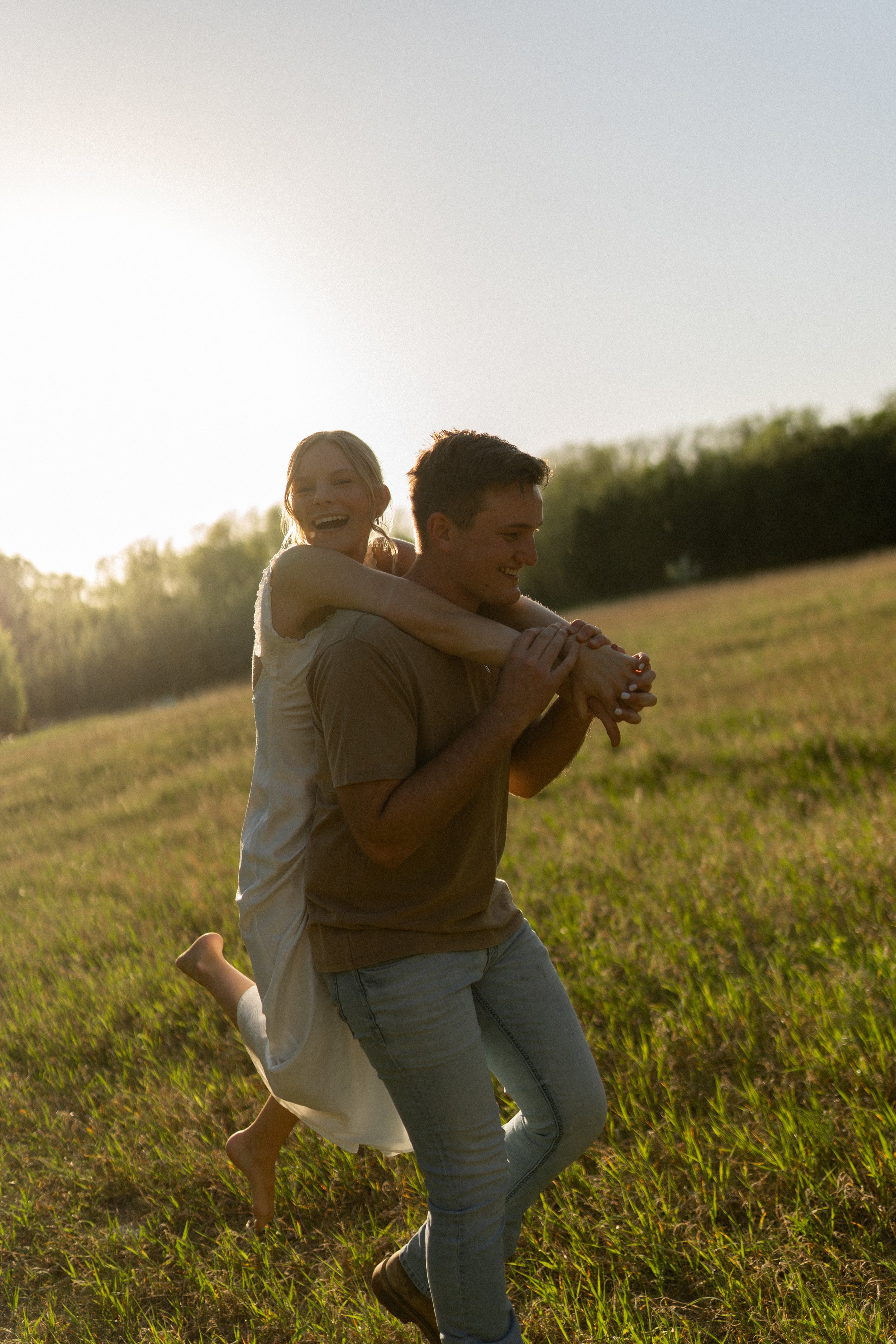 Detroit Lakes engagement session couple hugging in sunset field by Aesthete Pix