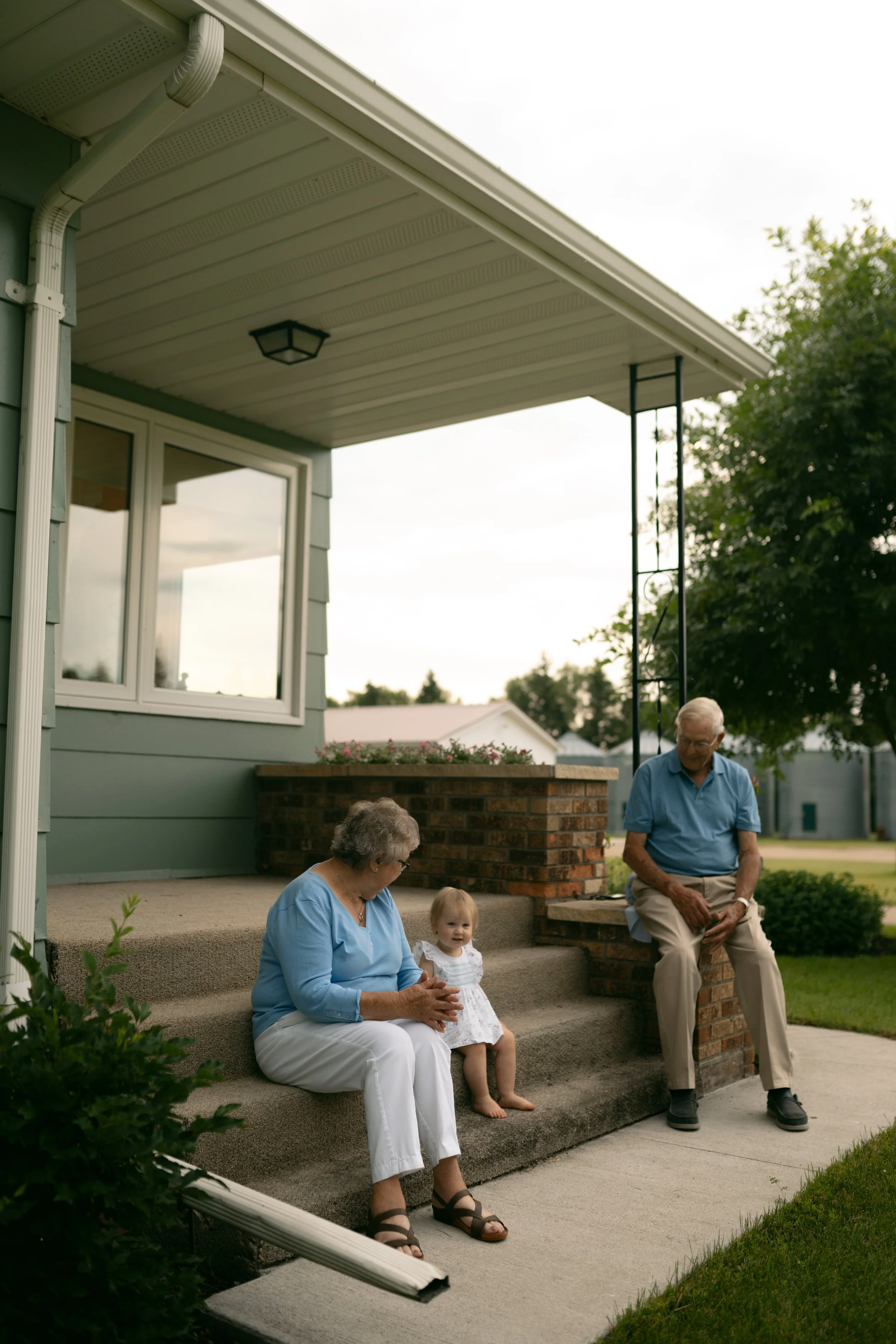 Fargo North Dakota family photography grandparents with grandchild on front porch by Aesthete Pix