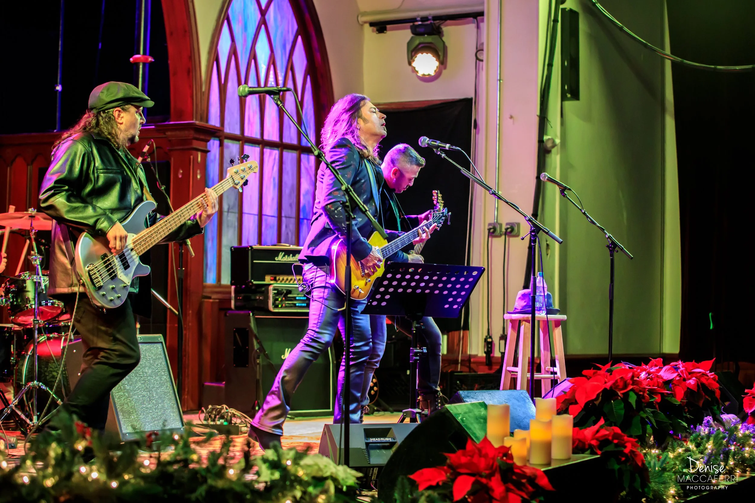 Digital artist, Concert lighting director, writer Woody Bavota, Michael Sweet performing on stage with guitars, one with long hair and a floral jacket, the other with short hair and a black jacket, against purple stage curtains.