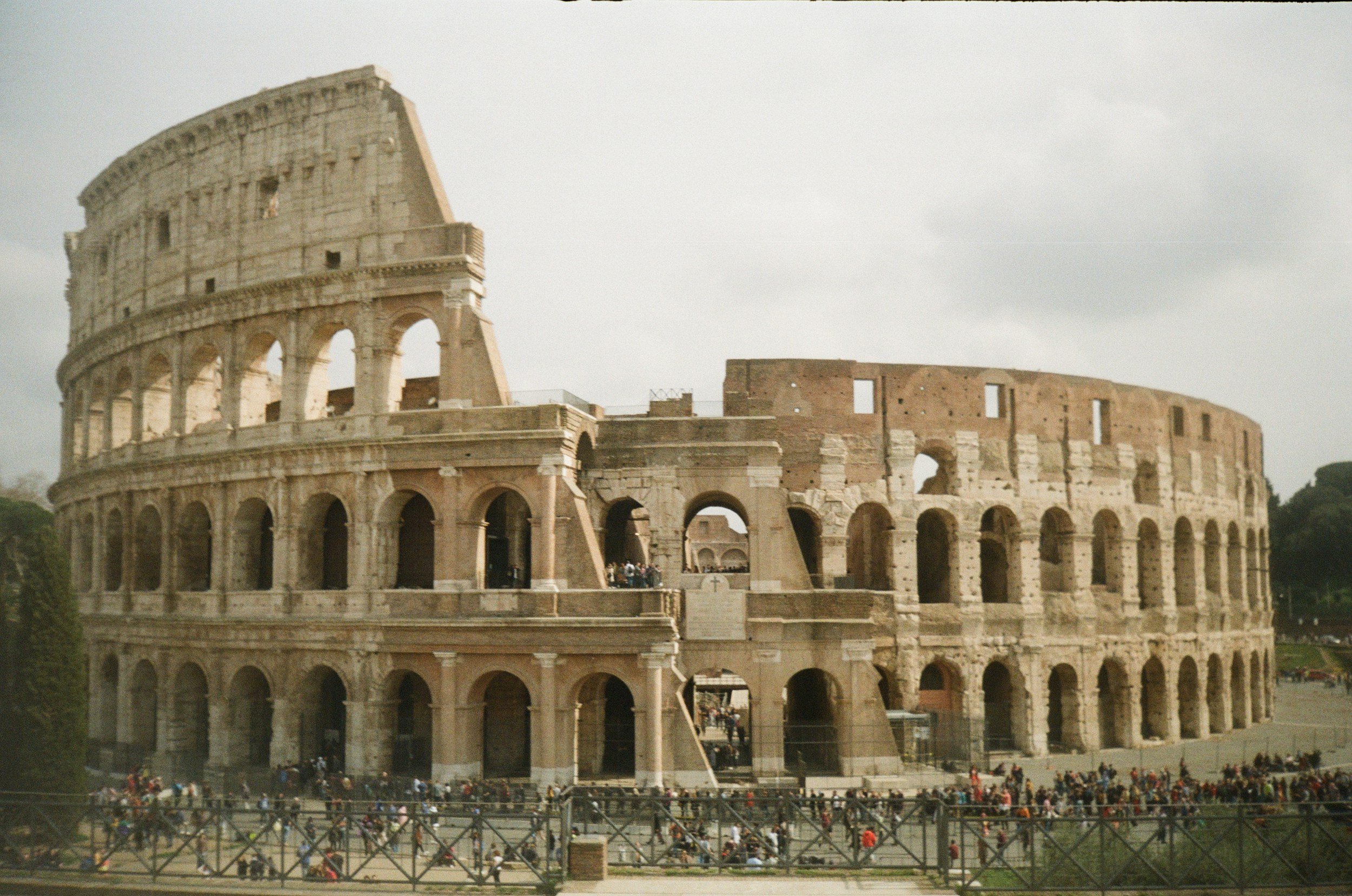 Photograph of the Roman Colosseum in Rome, Italy, filled with tourists and visitors.