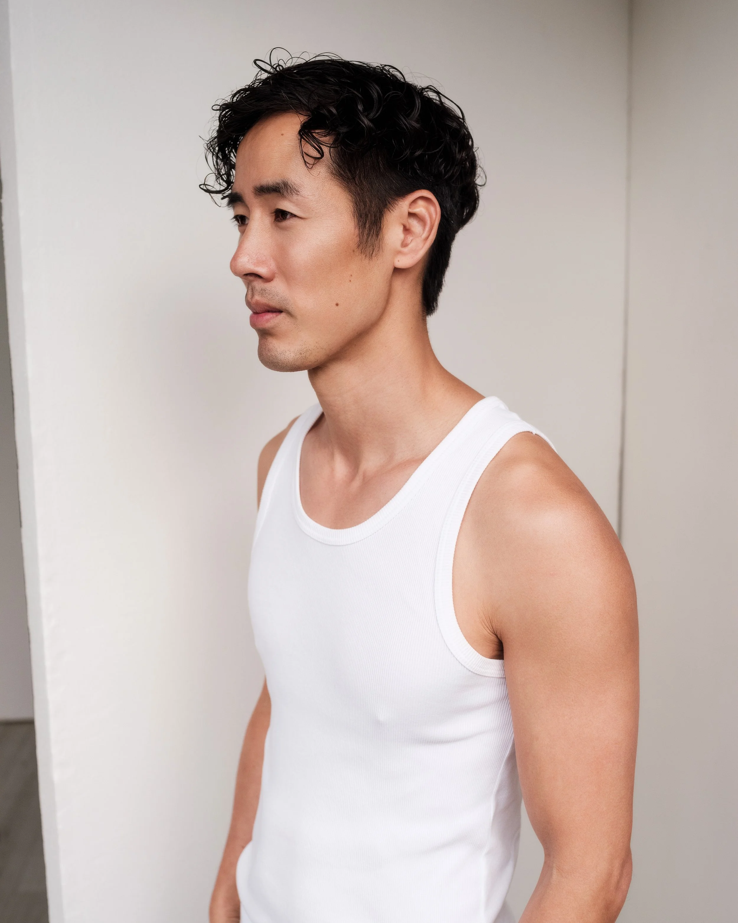 Ray Yee in a white singlet, side profile, model digitals