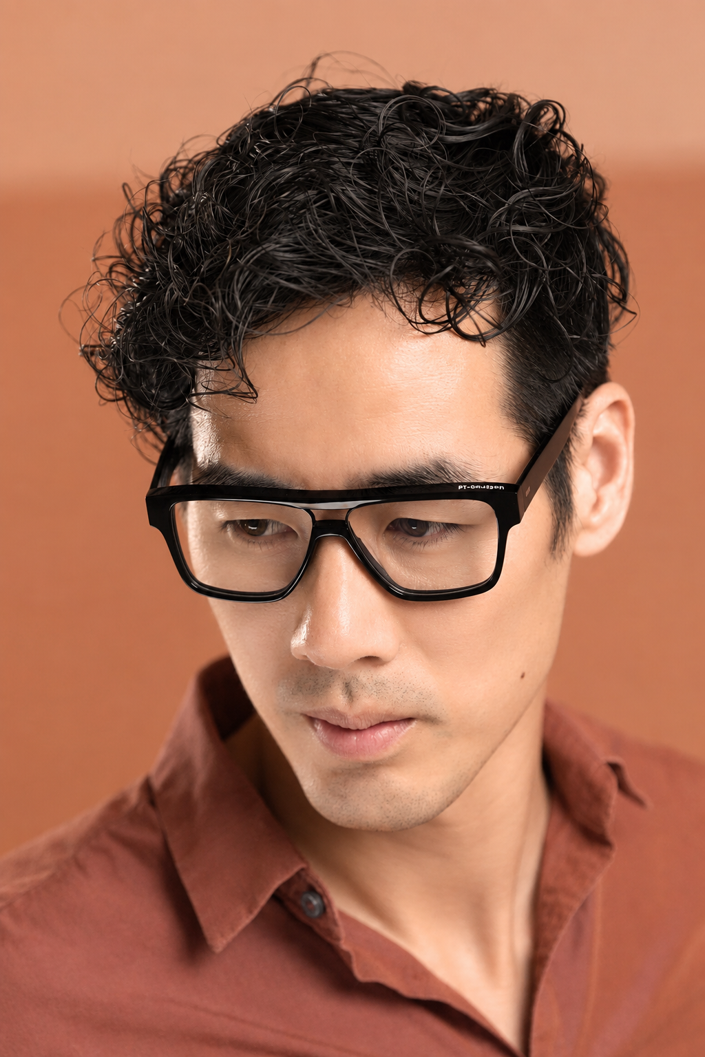 Ray Yee wearing black glasses and a brown shirt, ODMA eyewear campaign