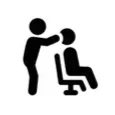 Person standing behind another person sitting in a chair