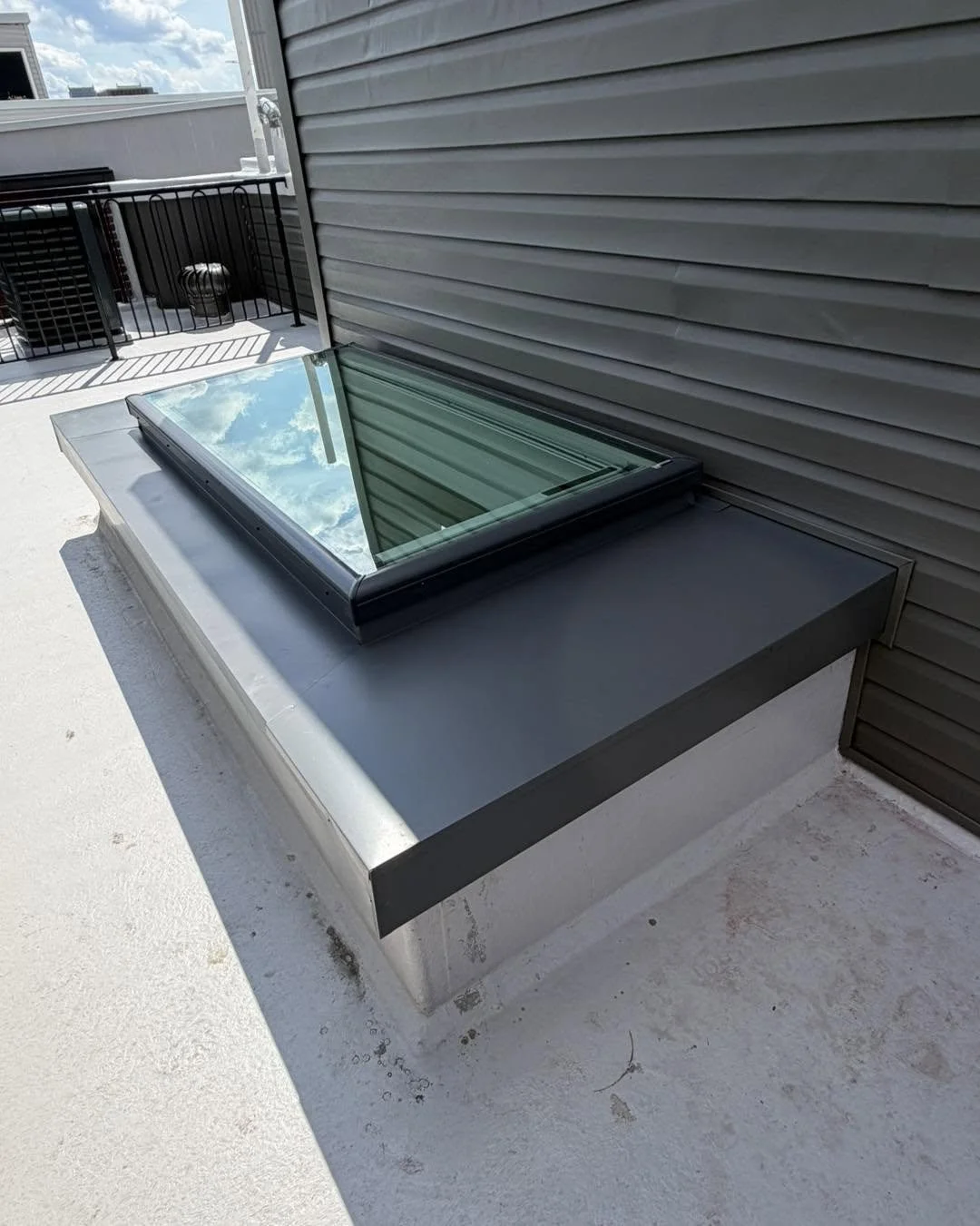 New energy-efficient glass skylight installed with finished trim and solar-powered blind