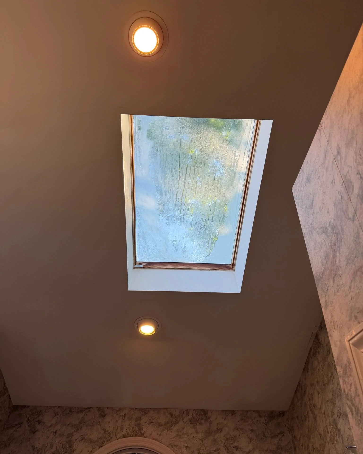 Cloudy skylight glass with condensation trapped between the panes in a Cherry Hill, NJ home
