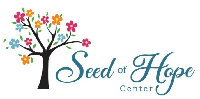 Logo for Seed of Hope Center featuring a stylized tree with colorful flowers as leaves and the text 'Seed of Hope Center' in elegant font.