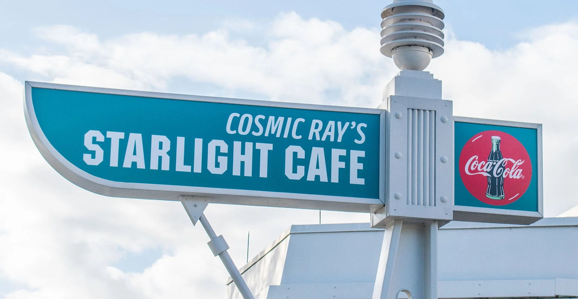 Outdoor photo of the Cosmic Ray's Starlight Cafe sign in Tomorrowland at Walt Disney World’s Magic Kingdom