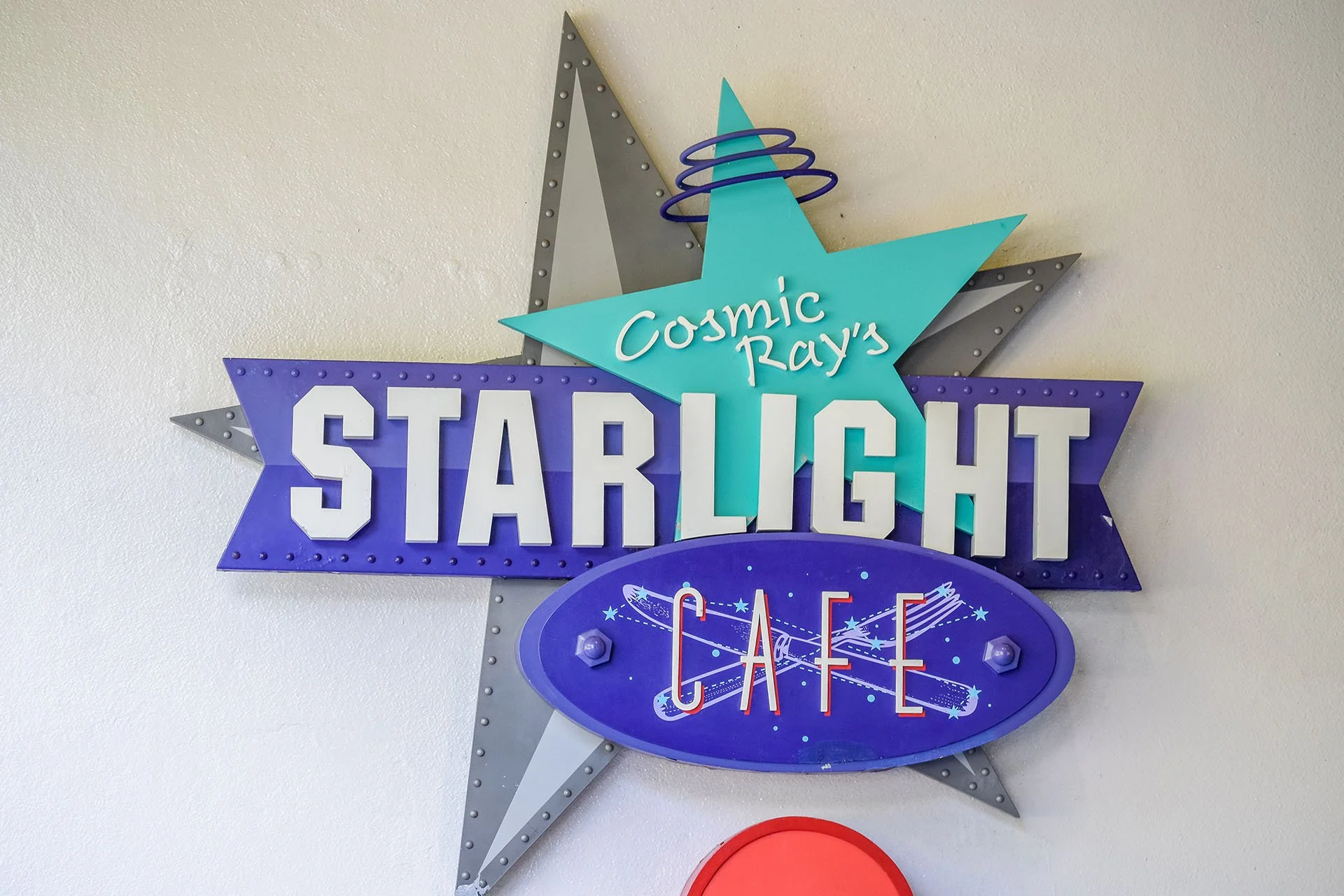 Outdoor photo of the Cosmic Ray's Starlight Cafe sign in Tomorrowland at Walt Disney World’s Magic Kingdom