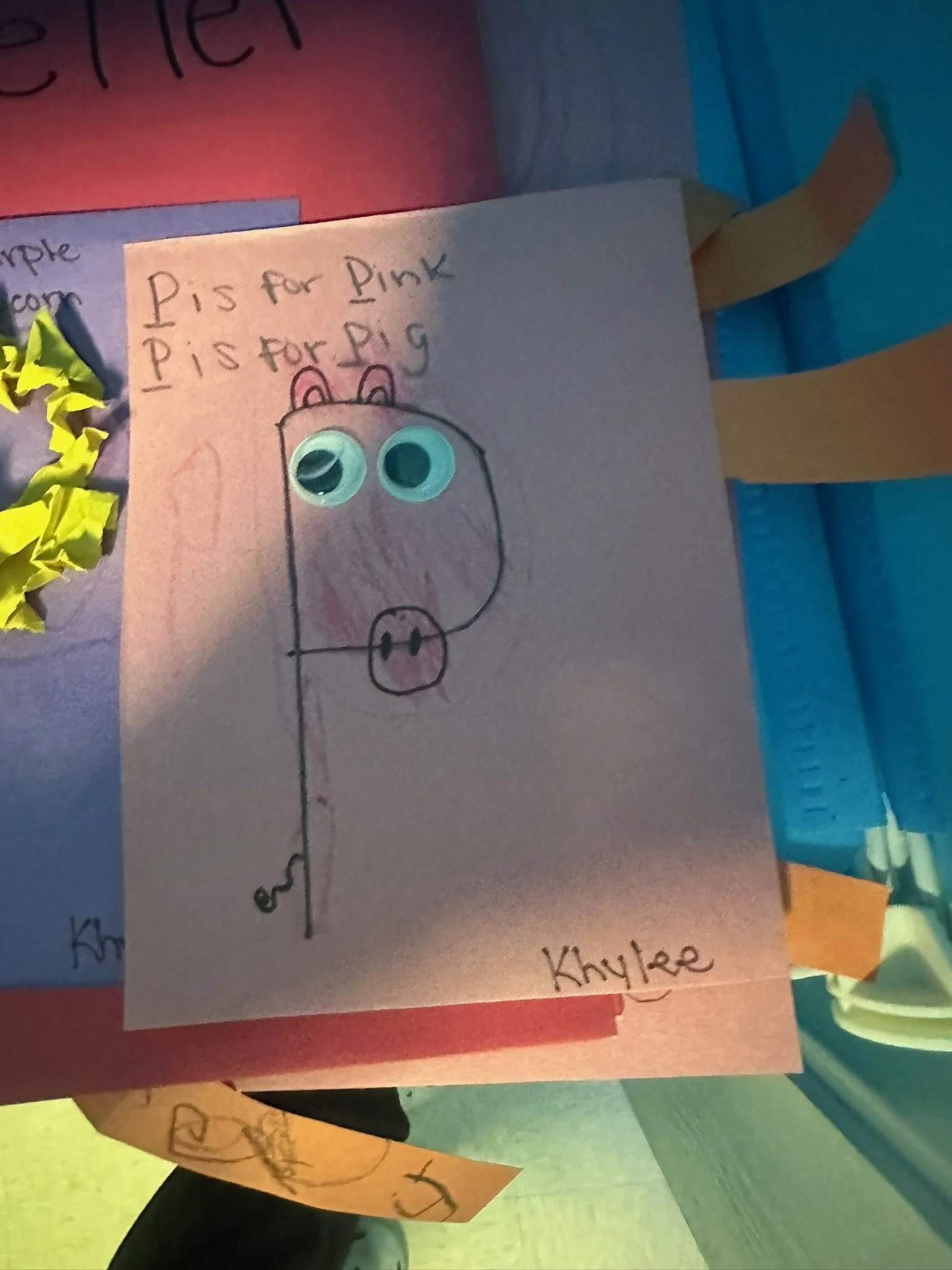 Handmade drawing of a pig with googly eyes, titled 'Pig for Pink' and signed 'Khylee'.
