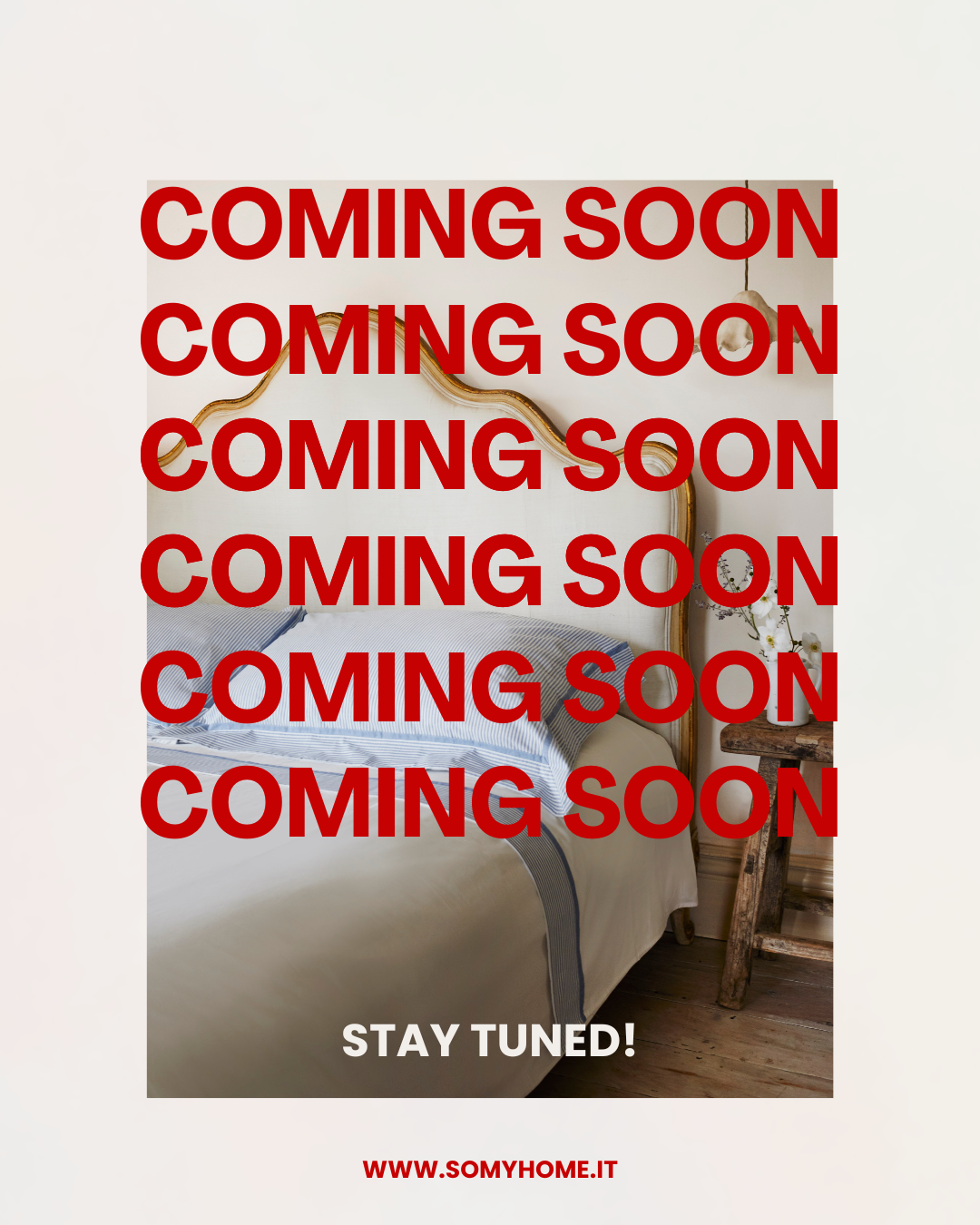 A bedroom with a bed, a rustic wooden side table with a small bouquet of white flowers, and a decorative gold headboard, overlaid with red text reading 'Coming Soon' multiple times and a white caption with black text that says 'Stay Tuned!' and a red website link at the bottom.