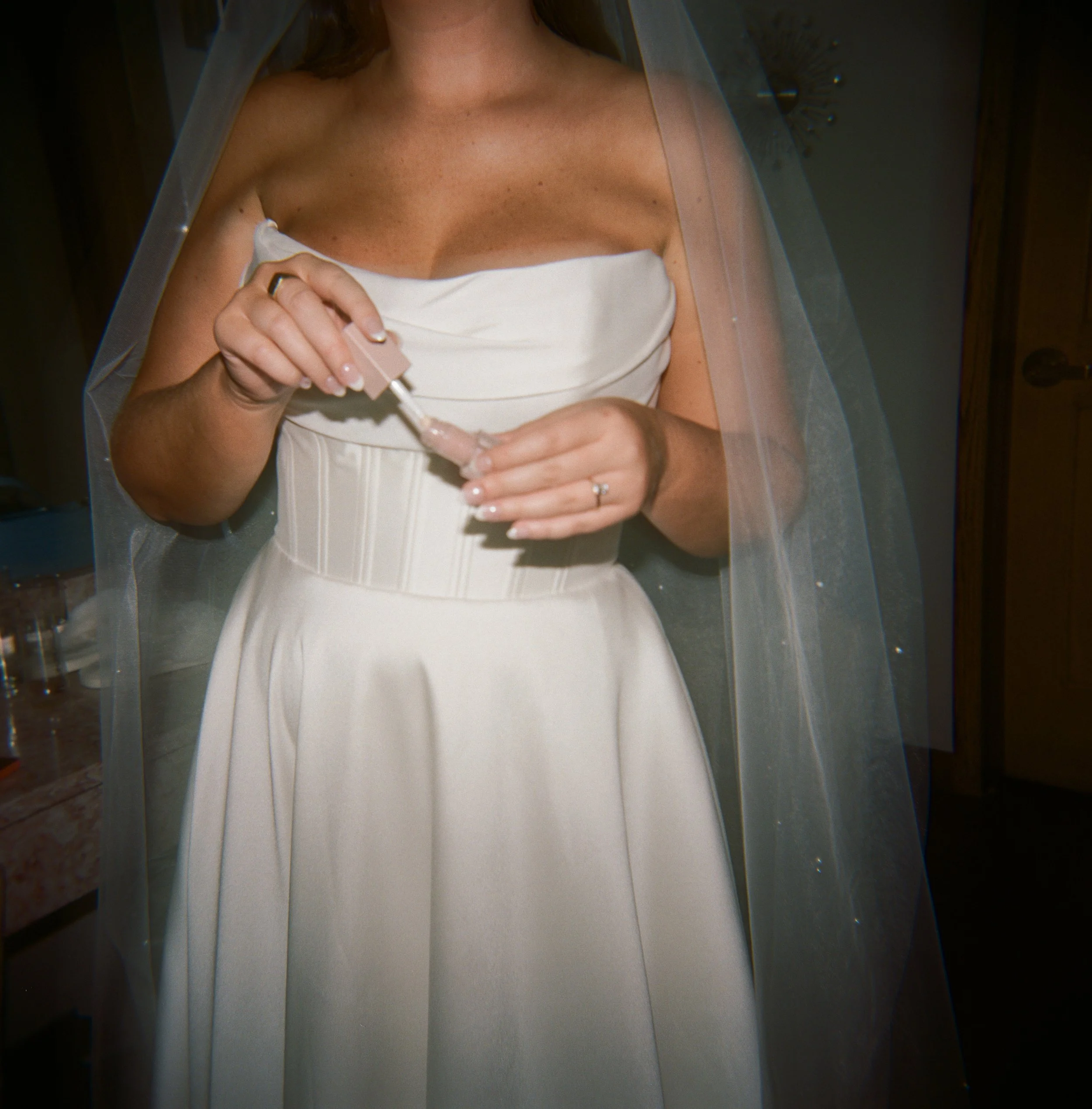 Bride getting ready beneath her veil in a modern wedding gown at The Lumigail wedding venue in Sevierville, Tennessee.