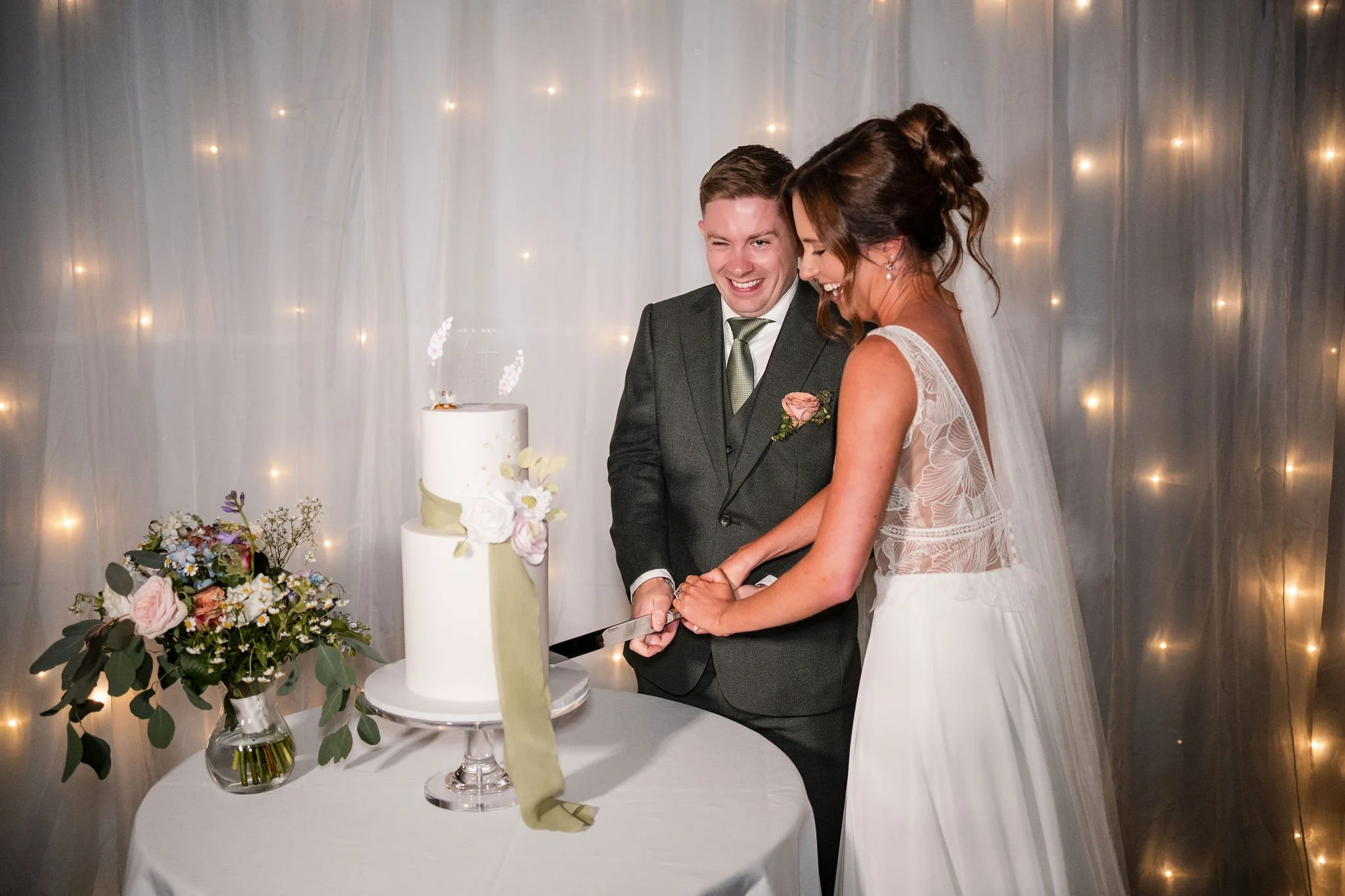 Lauren and Aiden cutting their wedding cake