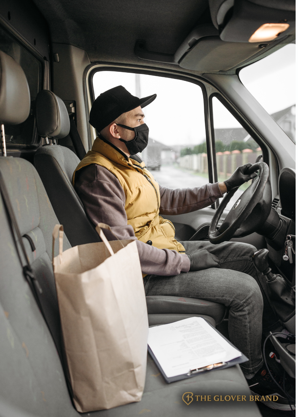 Medical courier driver for The Glover Brand sitting in delivery vehicle with protective mask, prepared for safe and compliant healthcare logistics transport across Georgia.