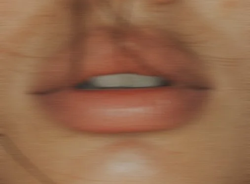 Close-up of a person's lips and mouth.