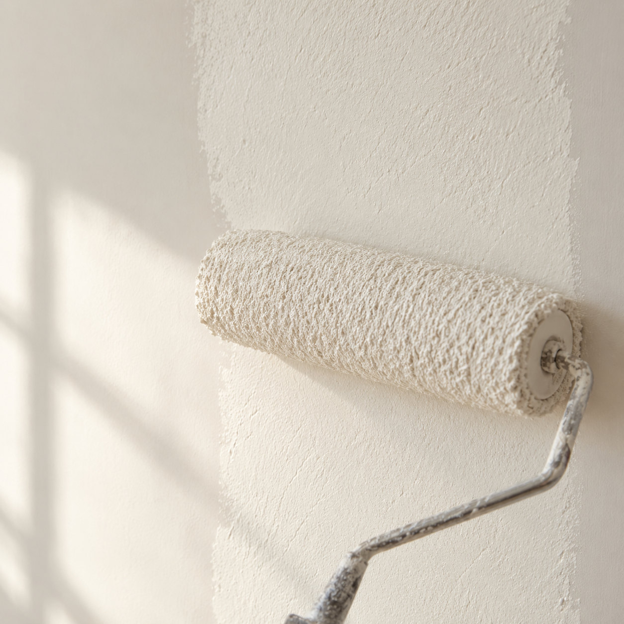 A paint roller covering an entire wall in one even coat, a metaphor for field-directed AK treatment.