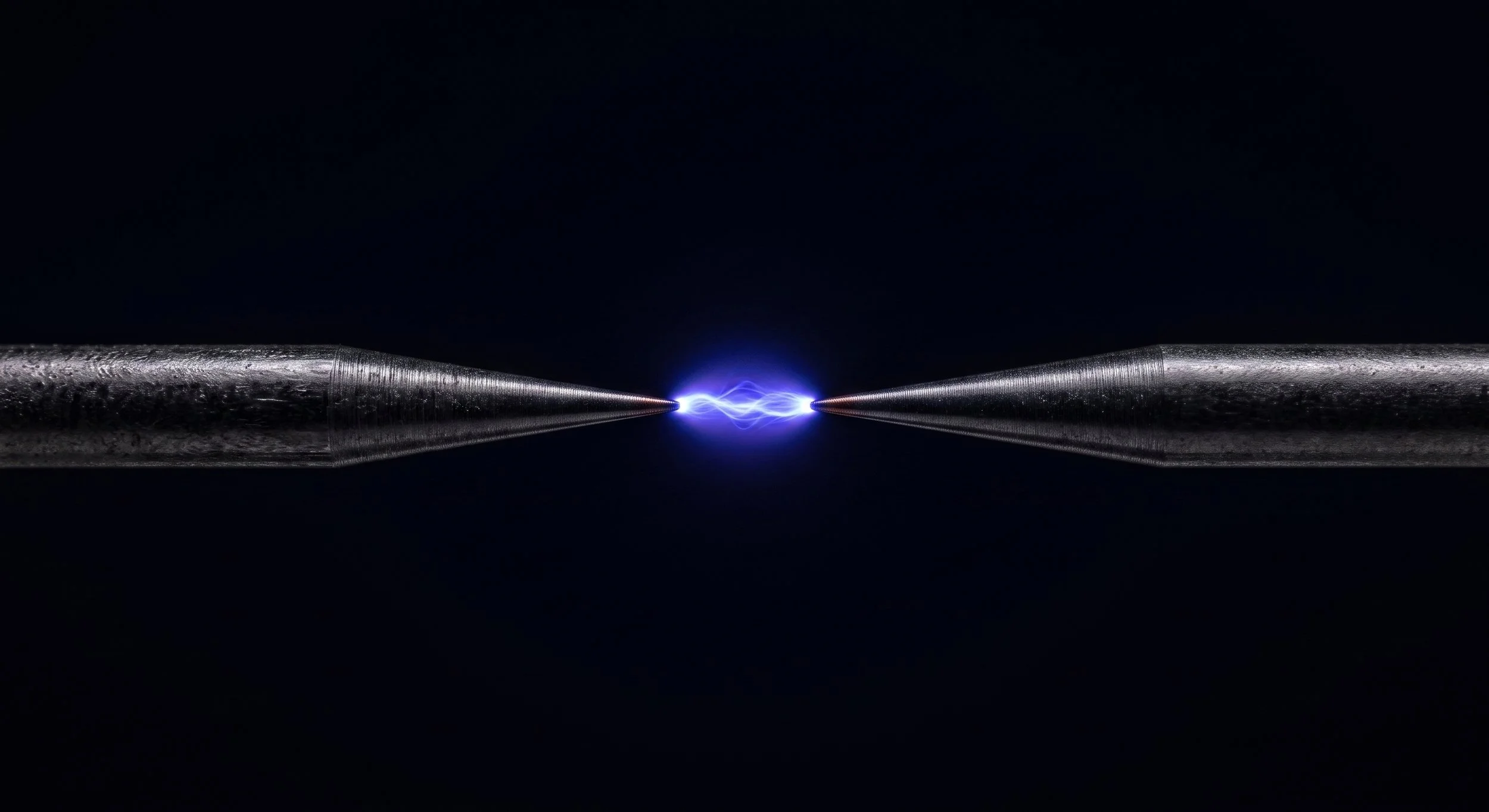 A small blue-violet electric arc glowing against a dark background, illustrating plasma-based skin treatment.