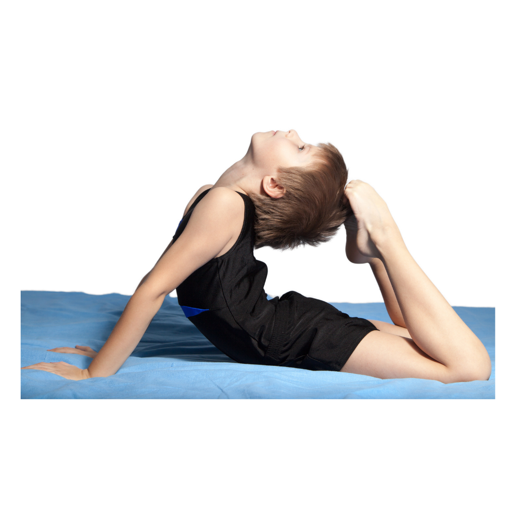 Young boy practicing yoga pose on blue mat, arching back and holding foot with hand.