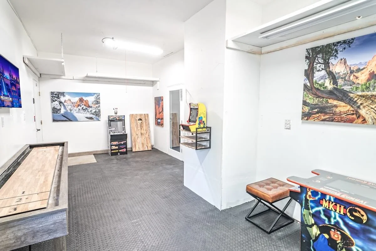 Game room with an air hockey table, arcade game, and wall art
