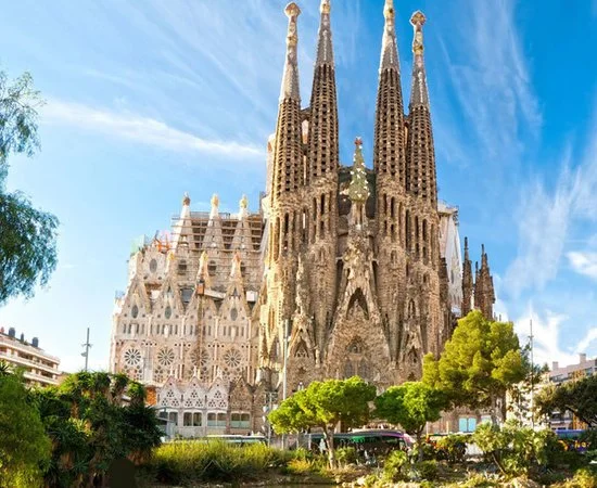 People standing close together, engaged in conversation, in a rustic, well-lit indoor setting with string lights.