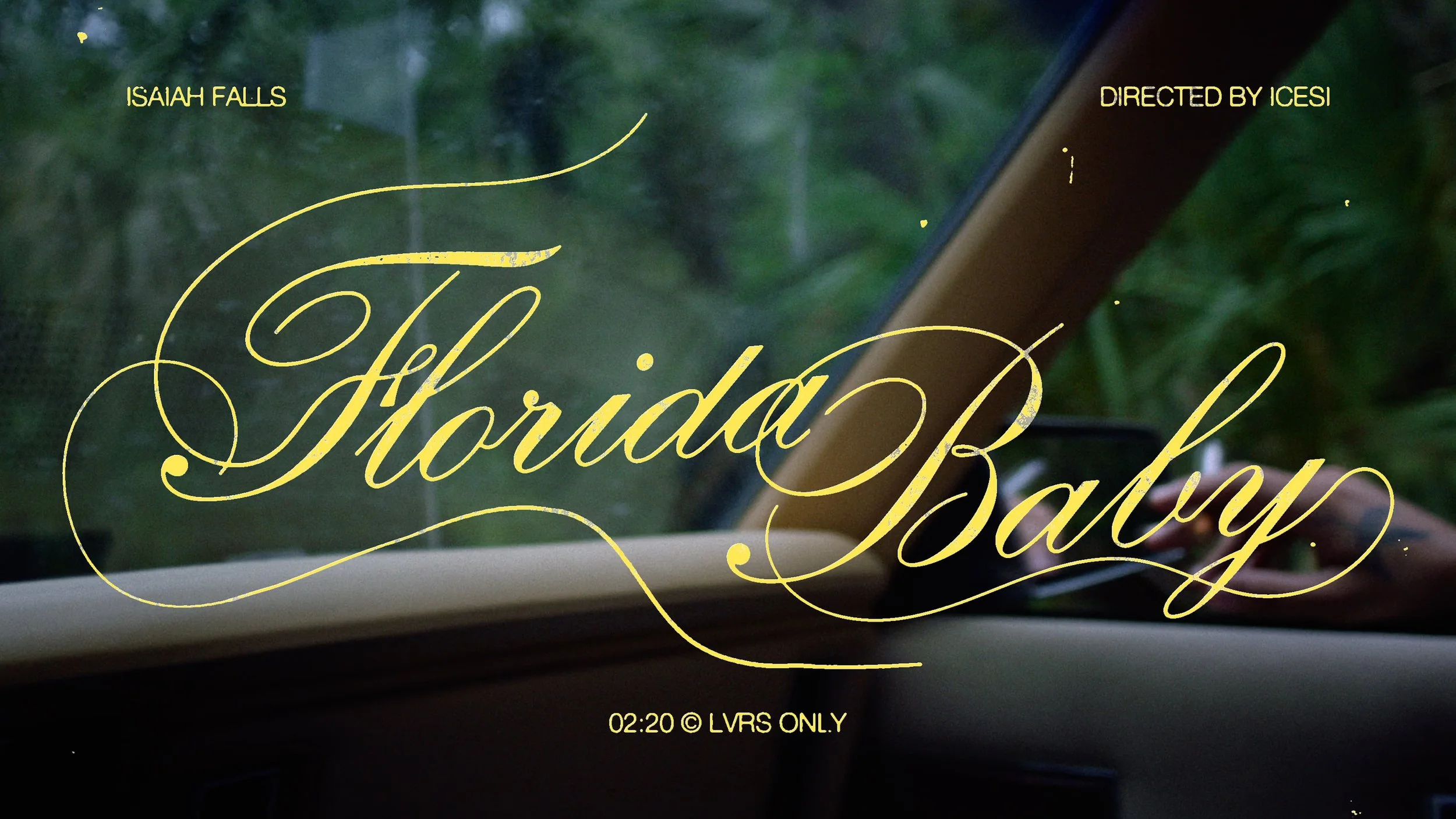 Text overlay on a window view with green trees and rain, reading 'Isaiah Falls', 'Directed by ICESI', 'Florída Baby', and '02:20 © LVRS ONLY'.