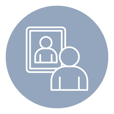 Person looking at a computer screen with a profile picture on it.