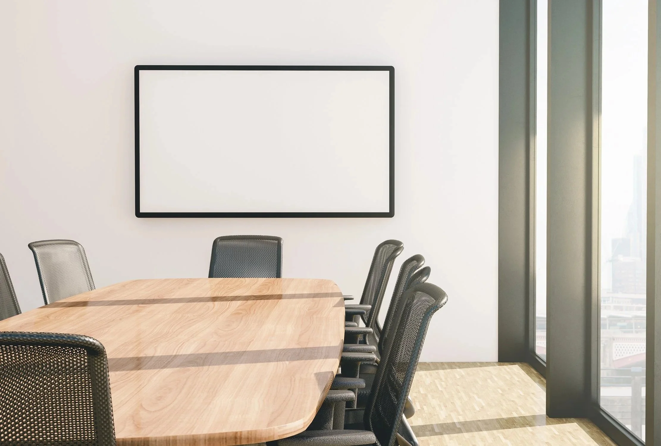 Empty modern conference room with a large wooden table, black mesh chairs, a blank whiteboard, and floor-to-ceiling windows showing a cityscape outside.