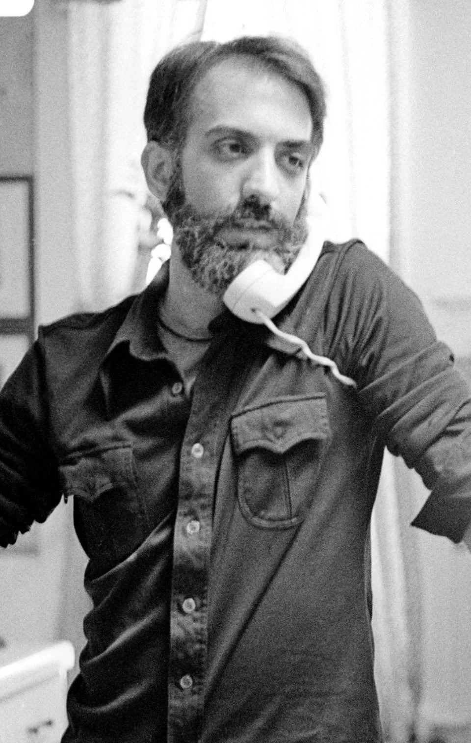 Raphael Iaccarino answers the phone in a black and white photo from the 1980s.