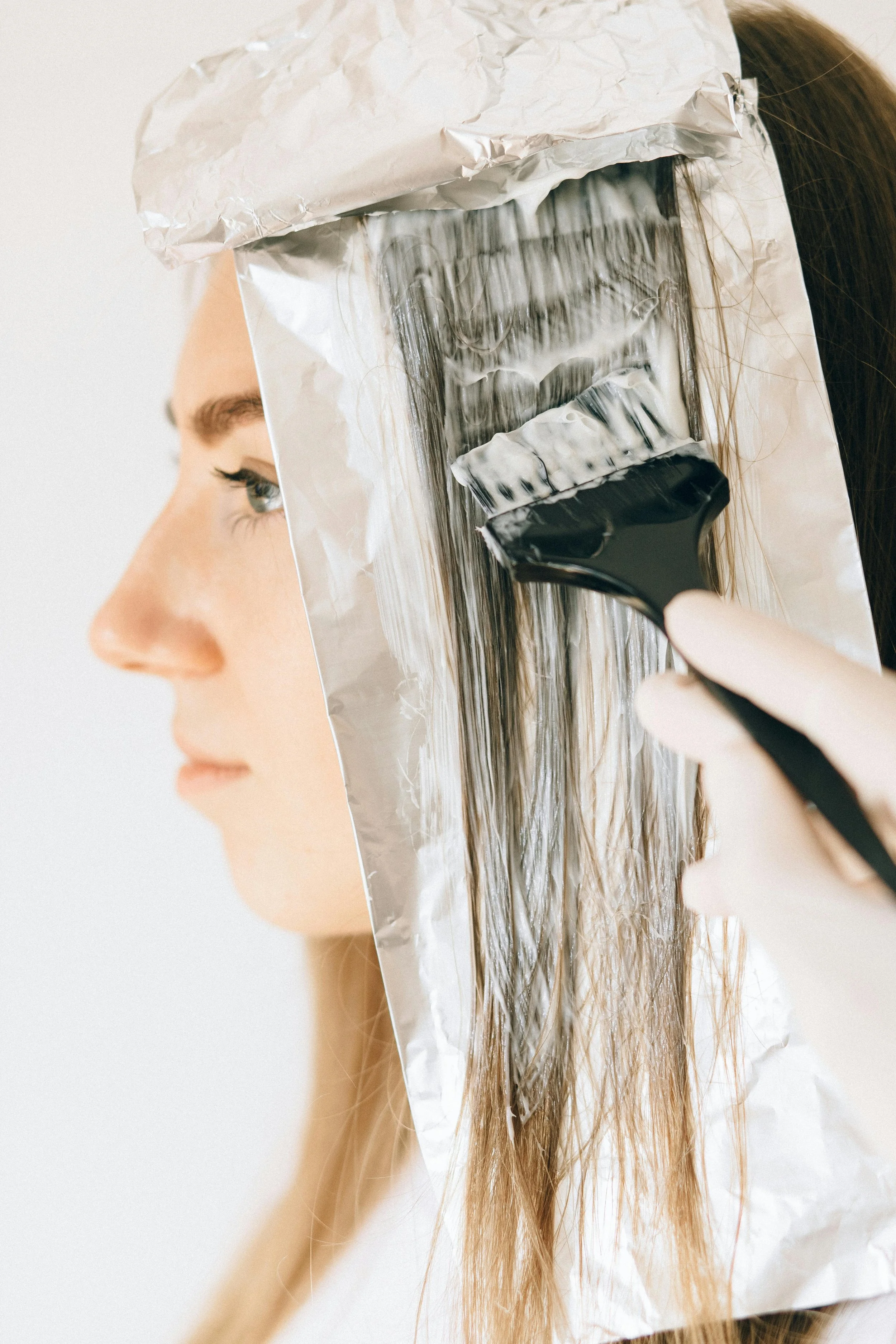 Soft, sun-kissed highlights framing the face at our Broadway hair salon