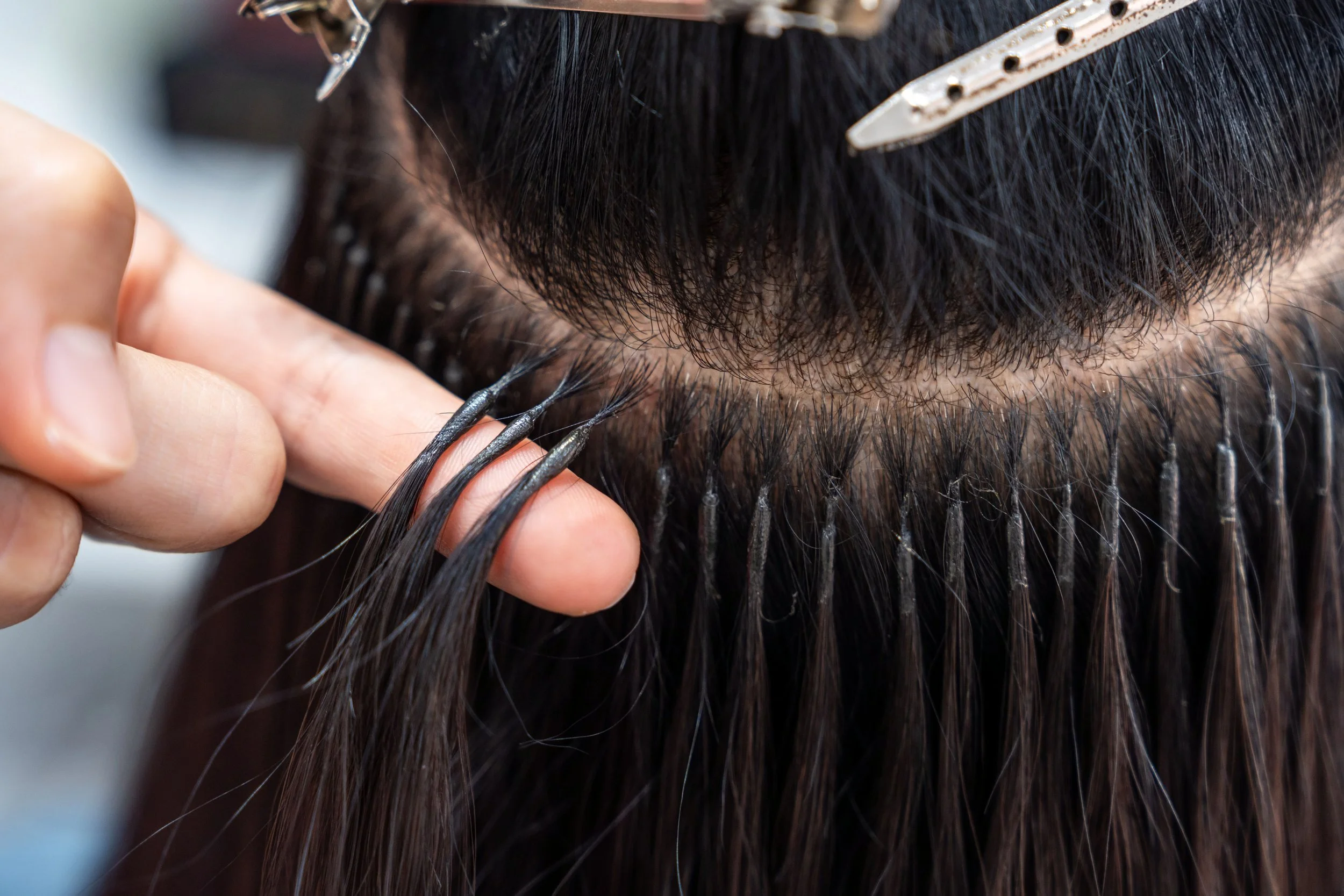 Long, voluminous hair after professional extension service in a San Antonio luxury salon