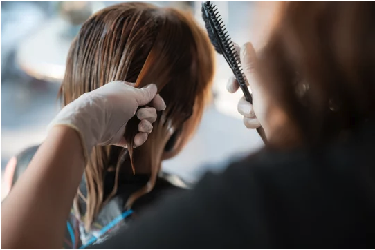 Guest with soft, manageable hair after keratin treatment in a San Antonio hair salon