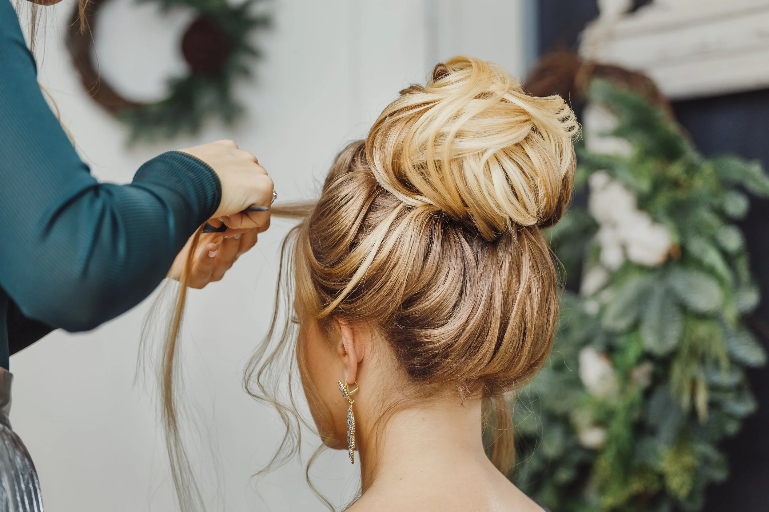 Sophisticated low bun and face-framing pieces for wedding or party hair at LOOK Salon San Antonio