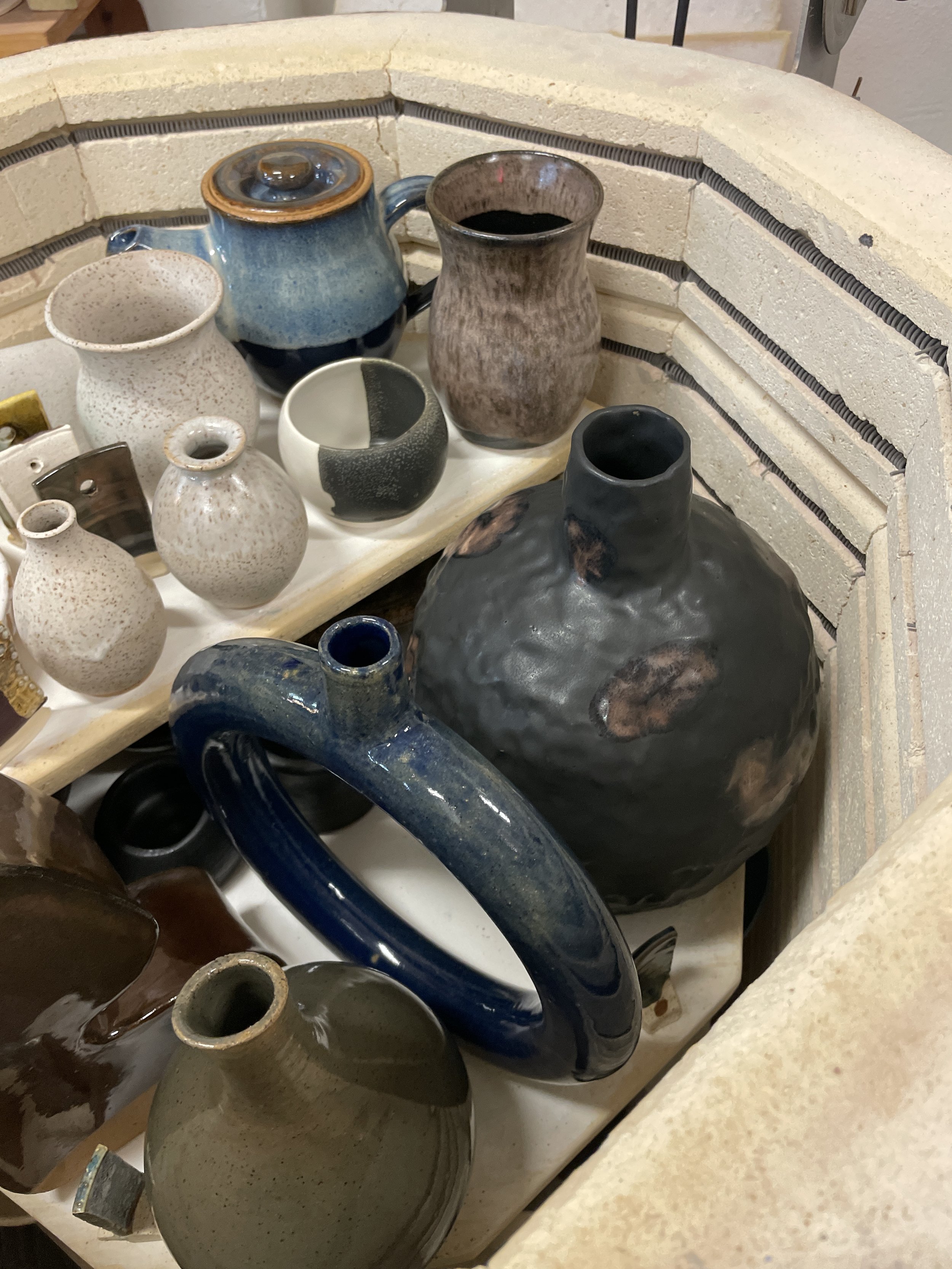 Member work in the kiln after being glazed and kiln fired.