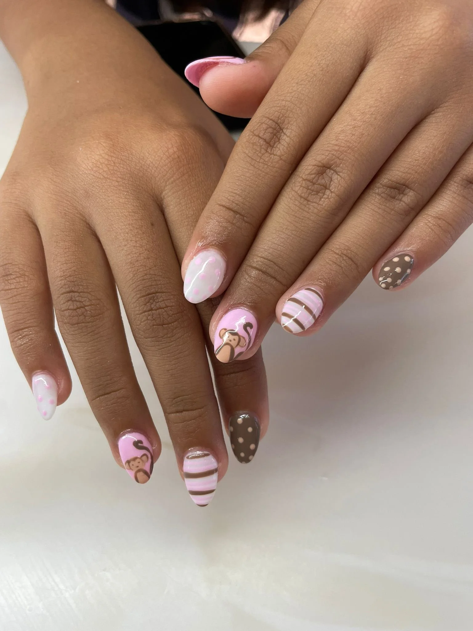 Kids monkey nail art manicure with pink and brown designs