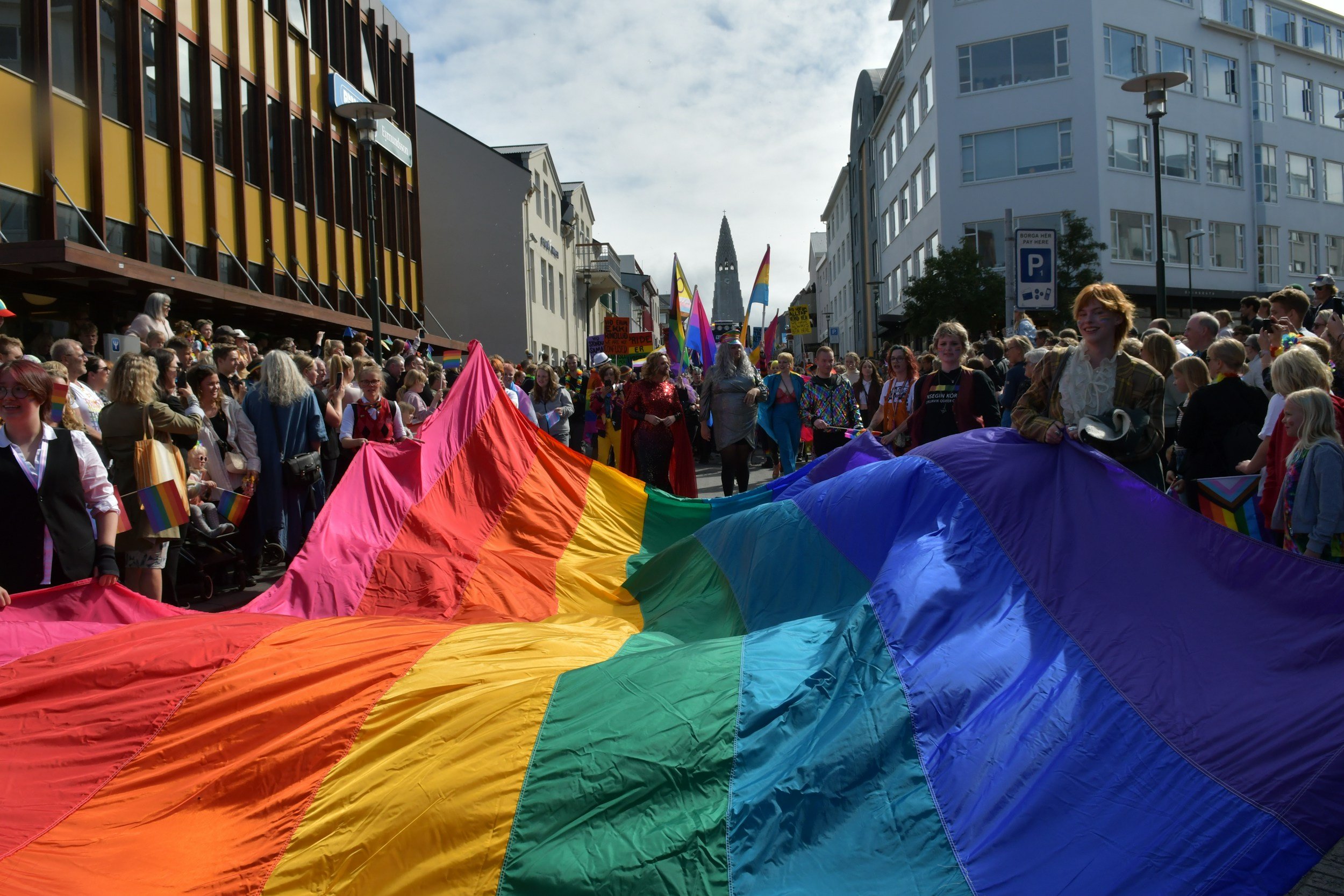 people walking with a rainbow flag