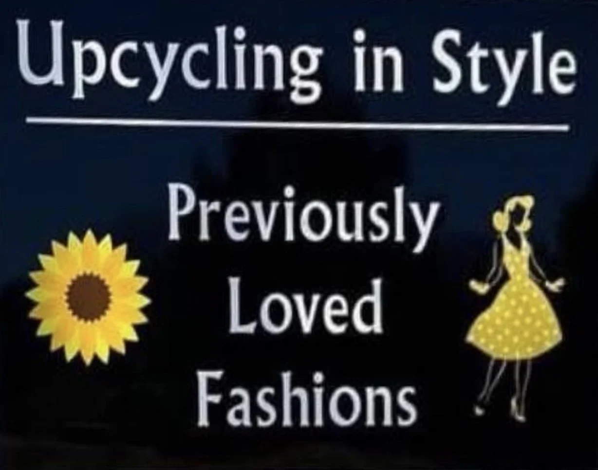 Sign that reads 'Upcycling in Style. Previously Loved Fashions' with a sunflower on the left and a illustration of a woman in a yellow polka dot dress on the right.