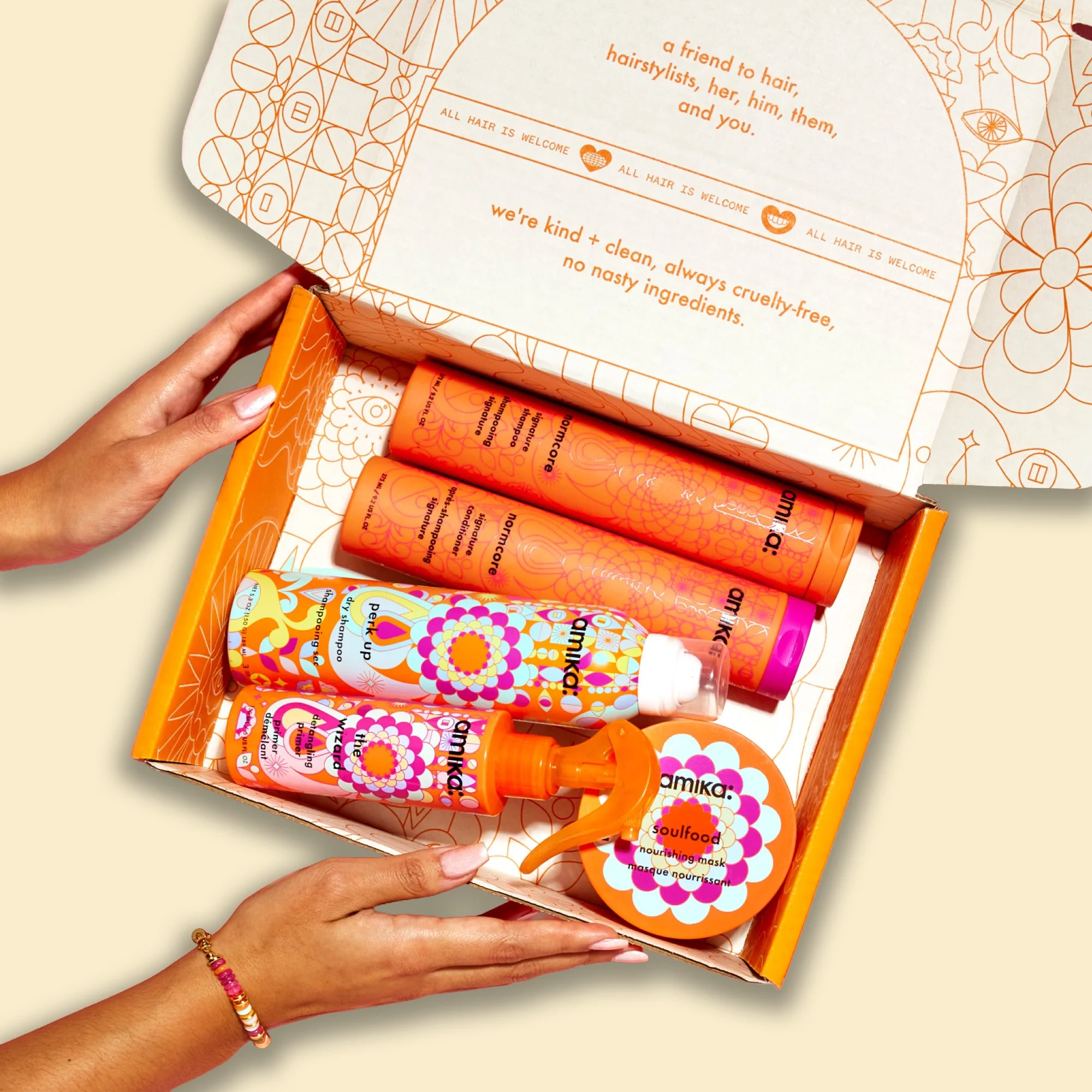 A photo showing a box containing colorful bottles of Amika hair product.
