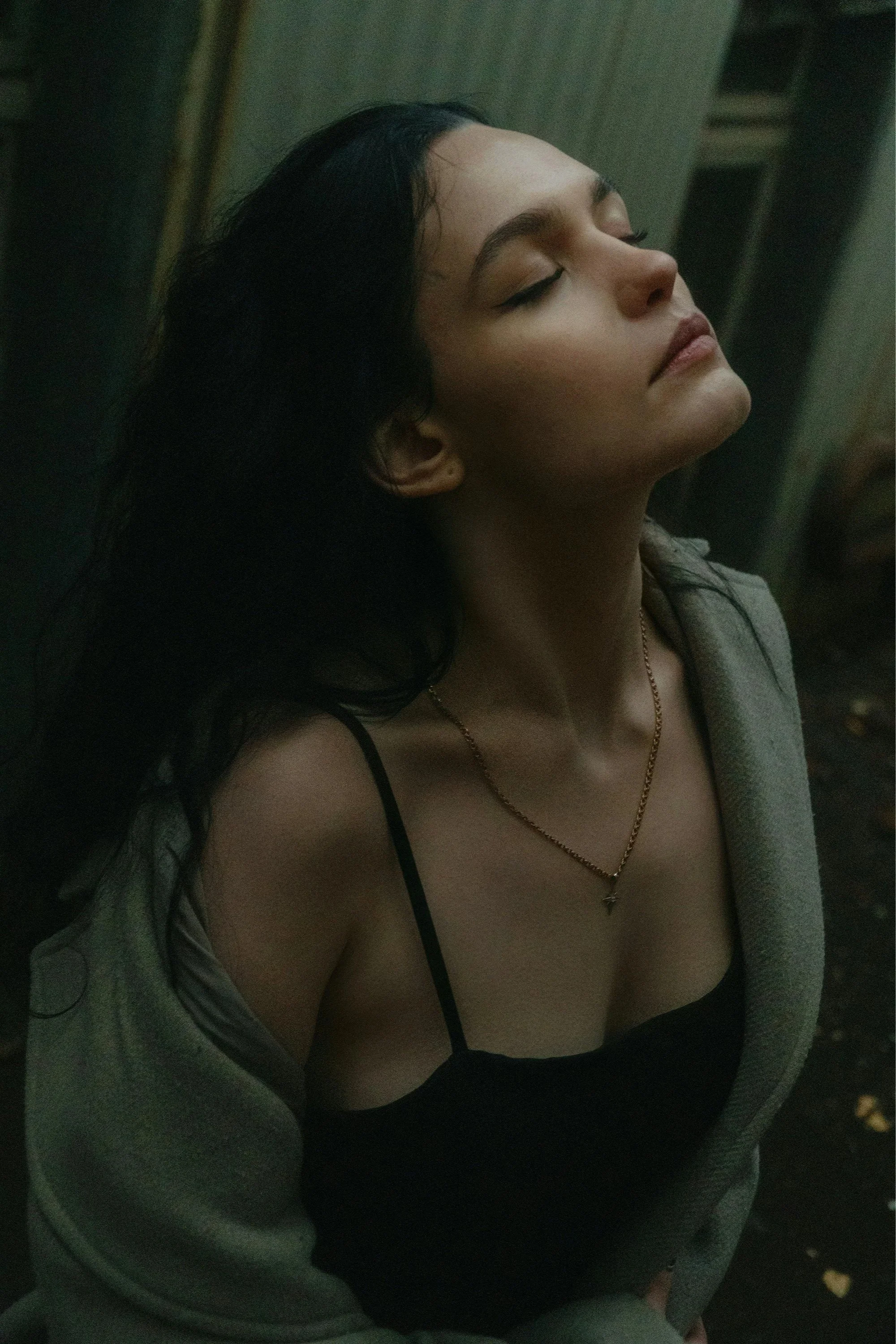 Woman with eyes closed and face lifted in stillness, embodying the Release and Claim somatic experience