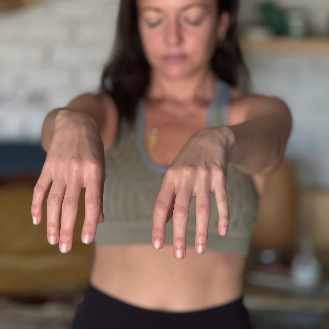 Woman with arms extended and eyes closed, scanning her body for held tension and suppression