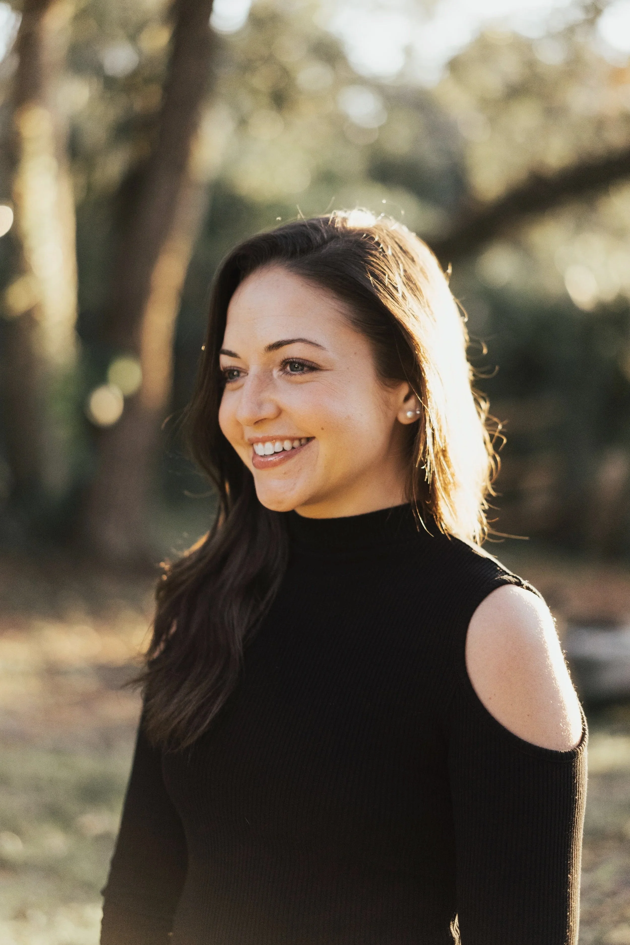 Priscilla Zorrilla, holistic coach and founder of In The Search Bar, smiling outdoors