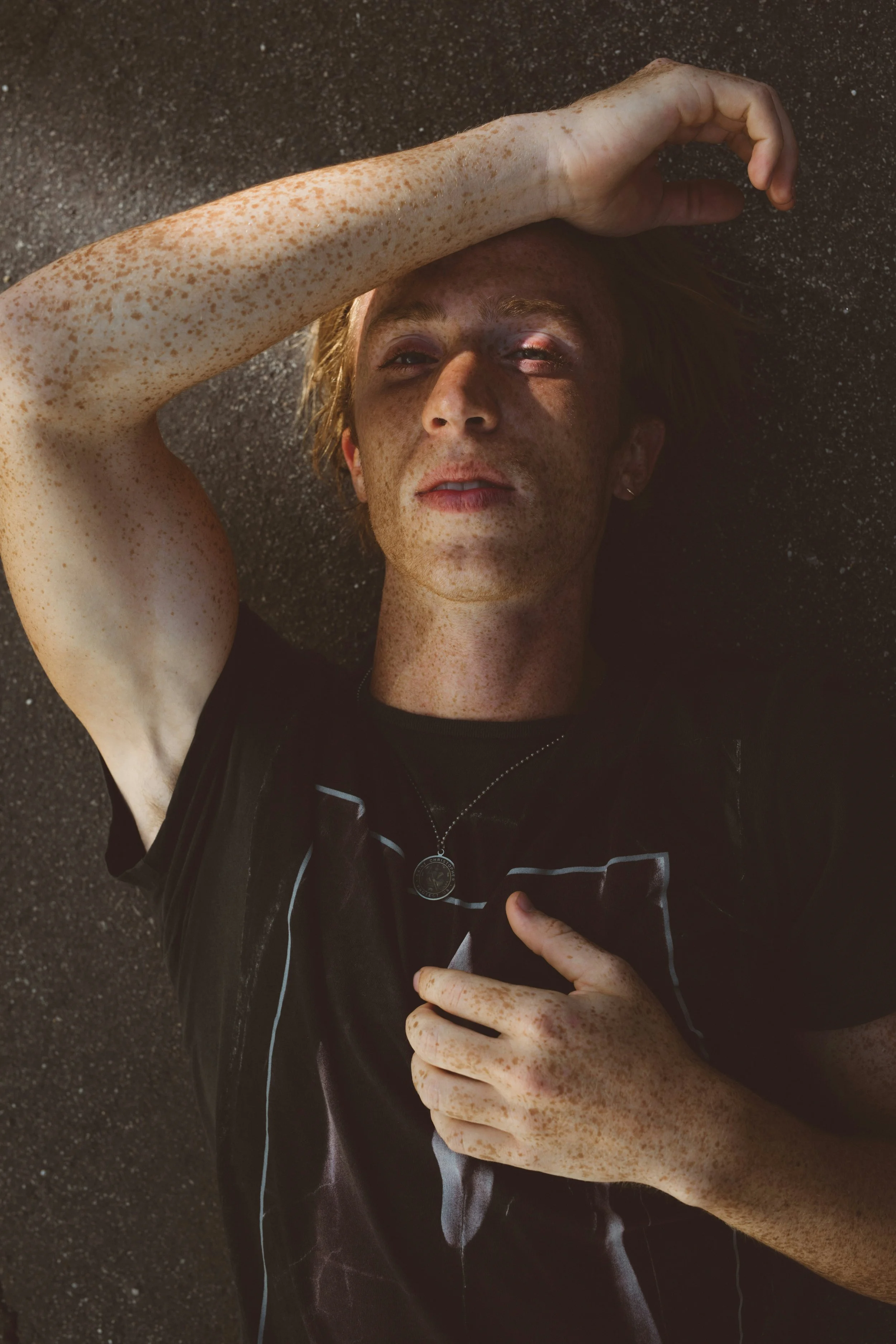 Man with hand on head in a moment of deep self-reflection, emotional awareness, and deep transformational somatic work