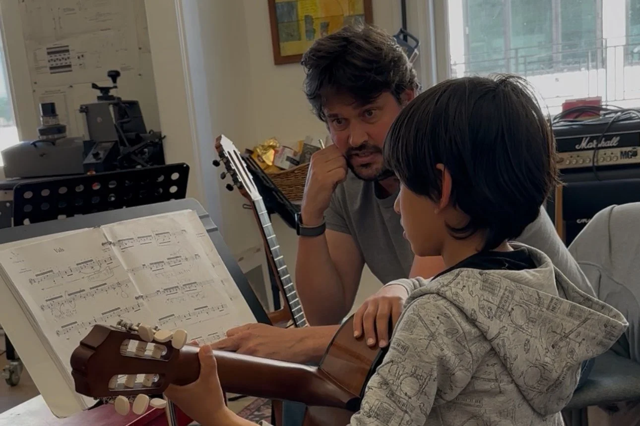 Anthony DeMers giving a young student a private classical guitar lesson in his Pacific Grove studio