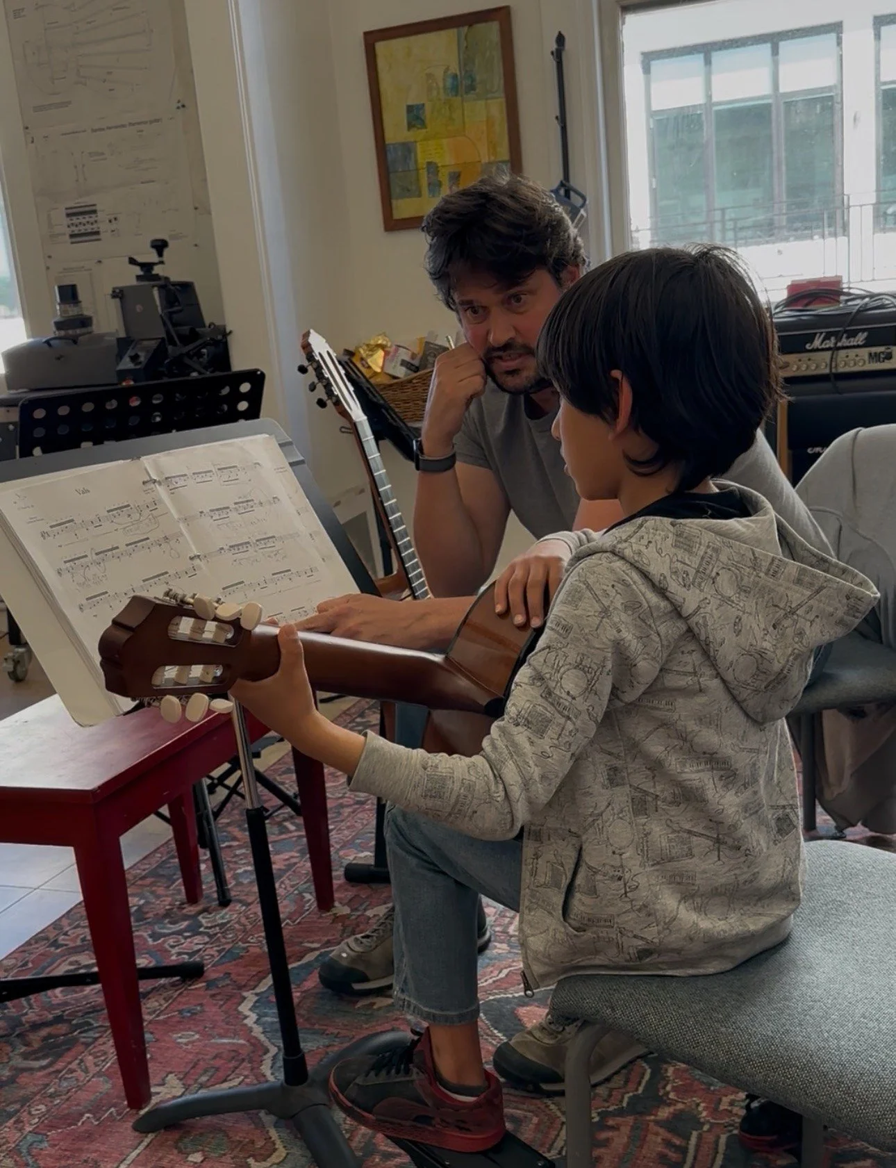 Anthony DeMers giving a young student a private classical guitar lesson in his Pacific Grove studio