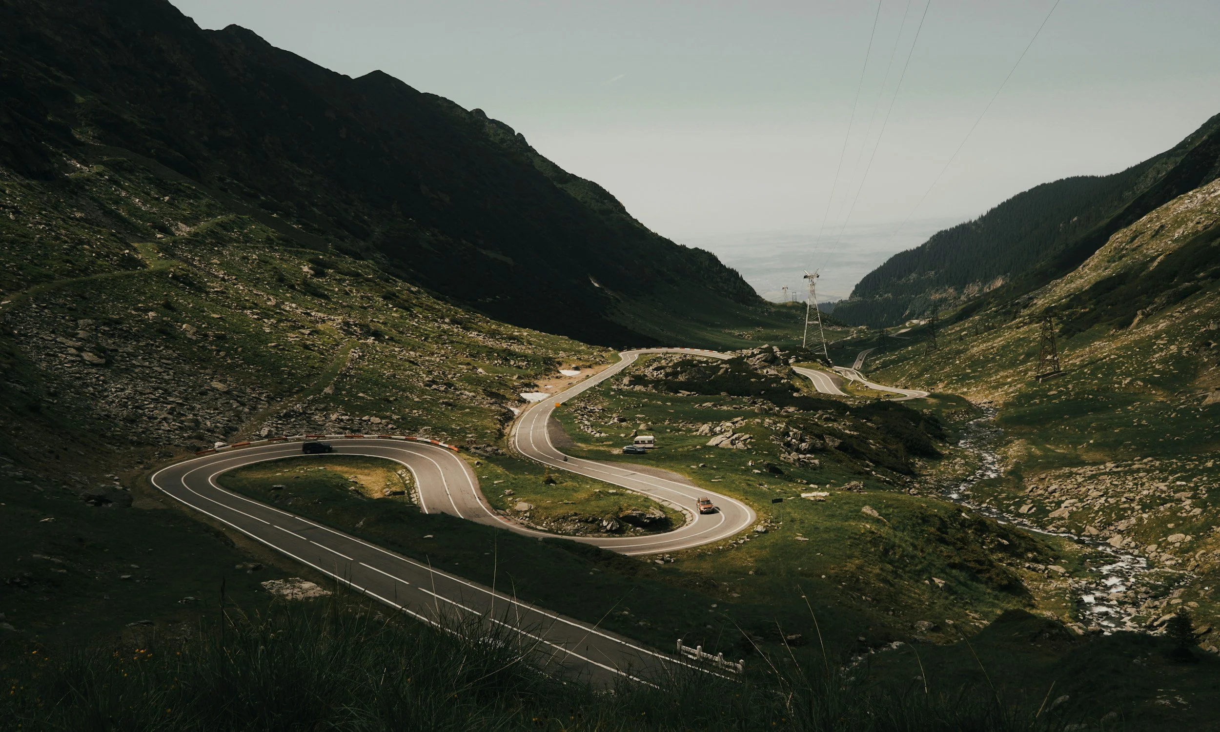 Road winding through a green mountain valley