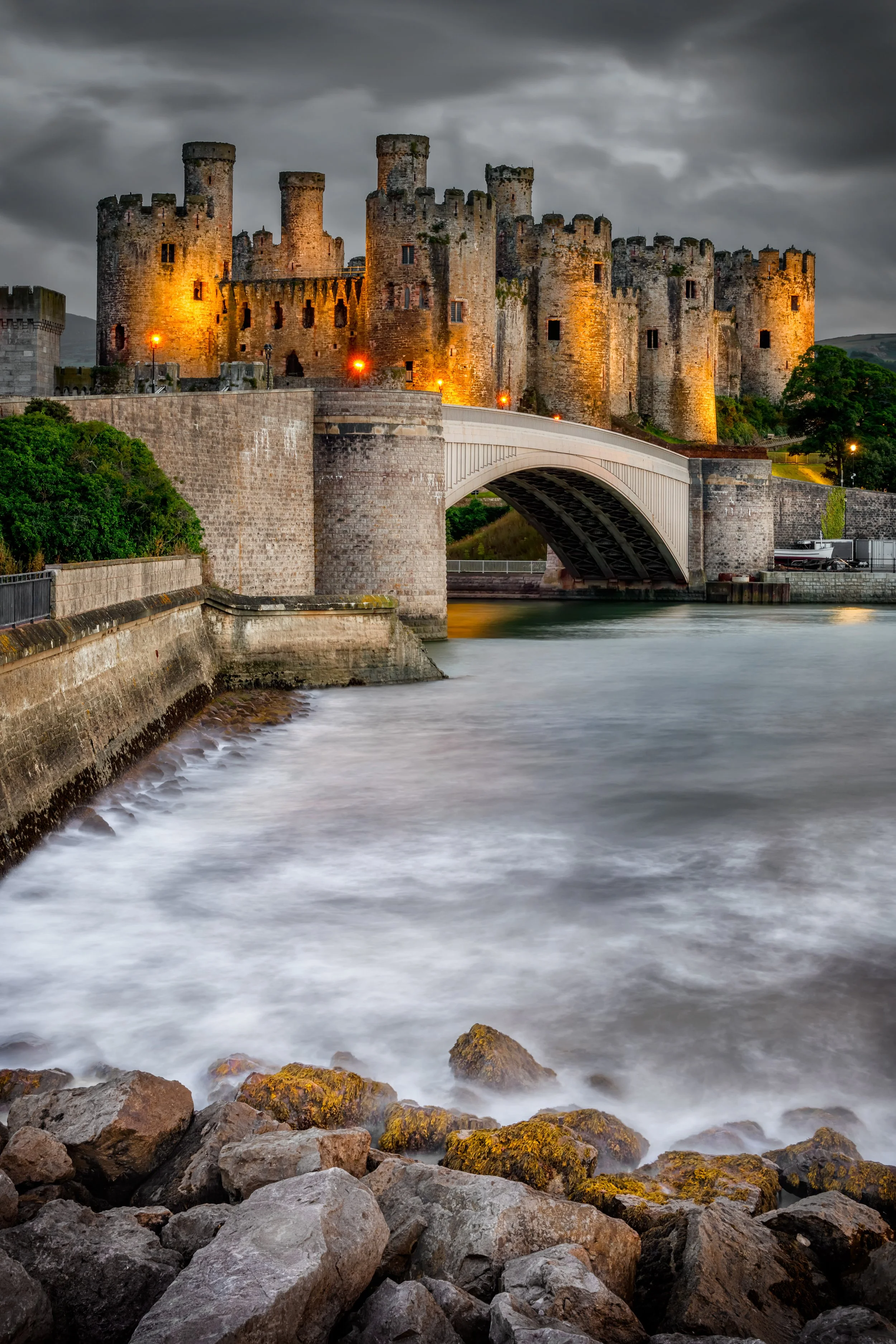 Conwy Castle rising above the town in evening light