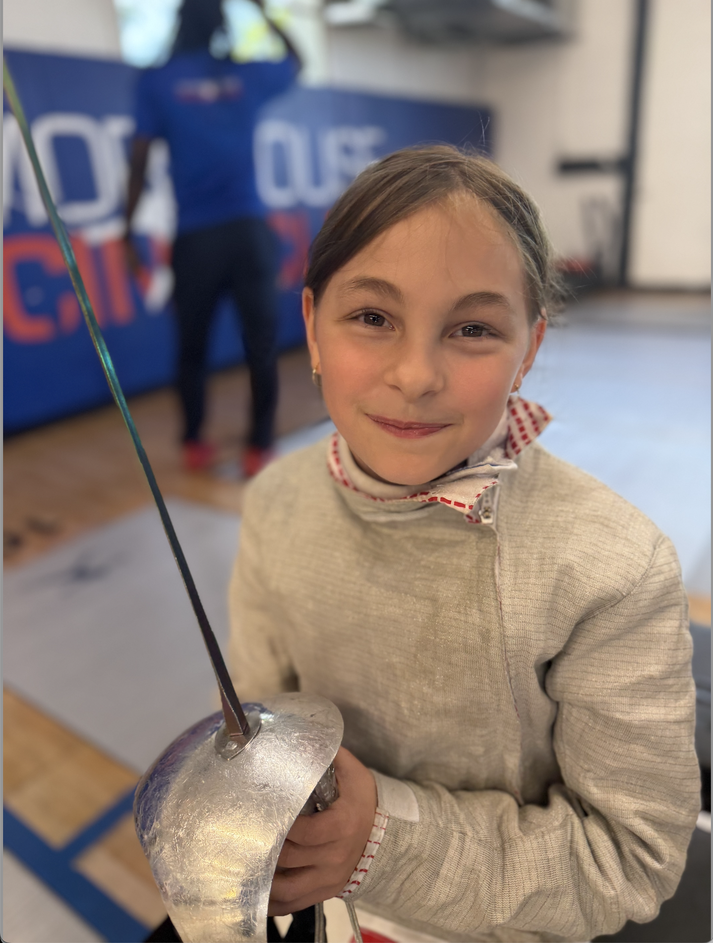 Young fencer holding a saber at TMFC Port Chester