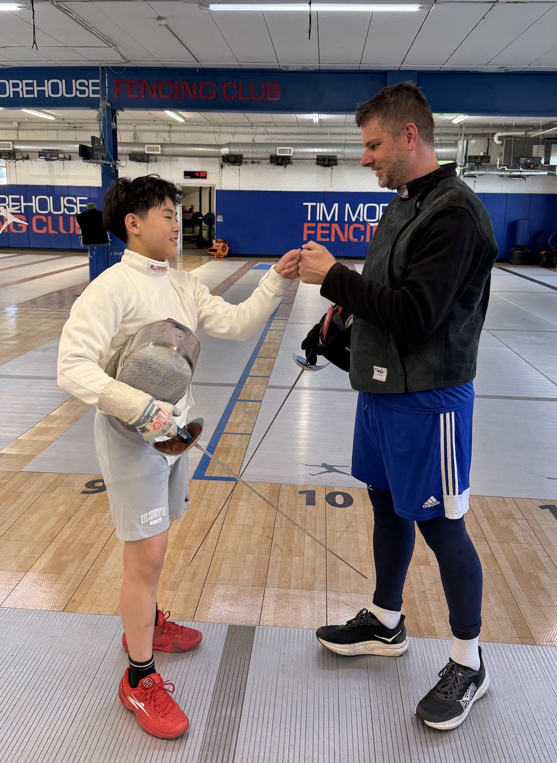 Young fencer in gear at Tim Morehouse Fencing Club summer camp