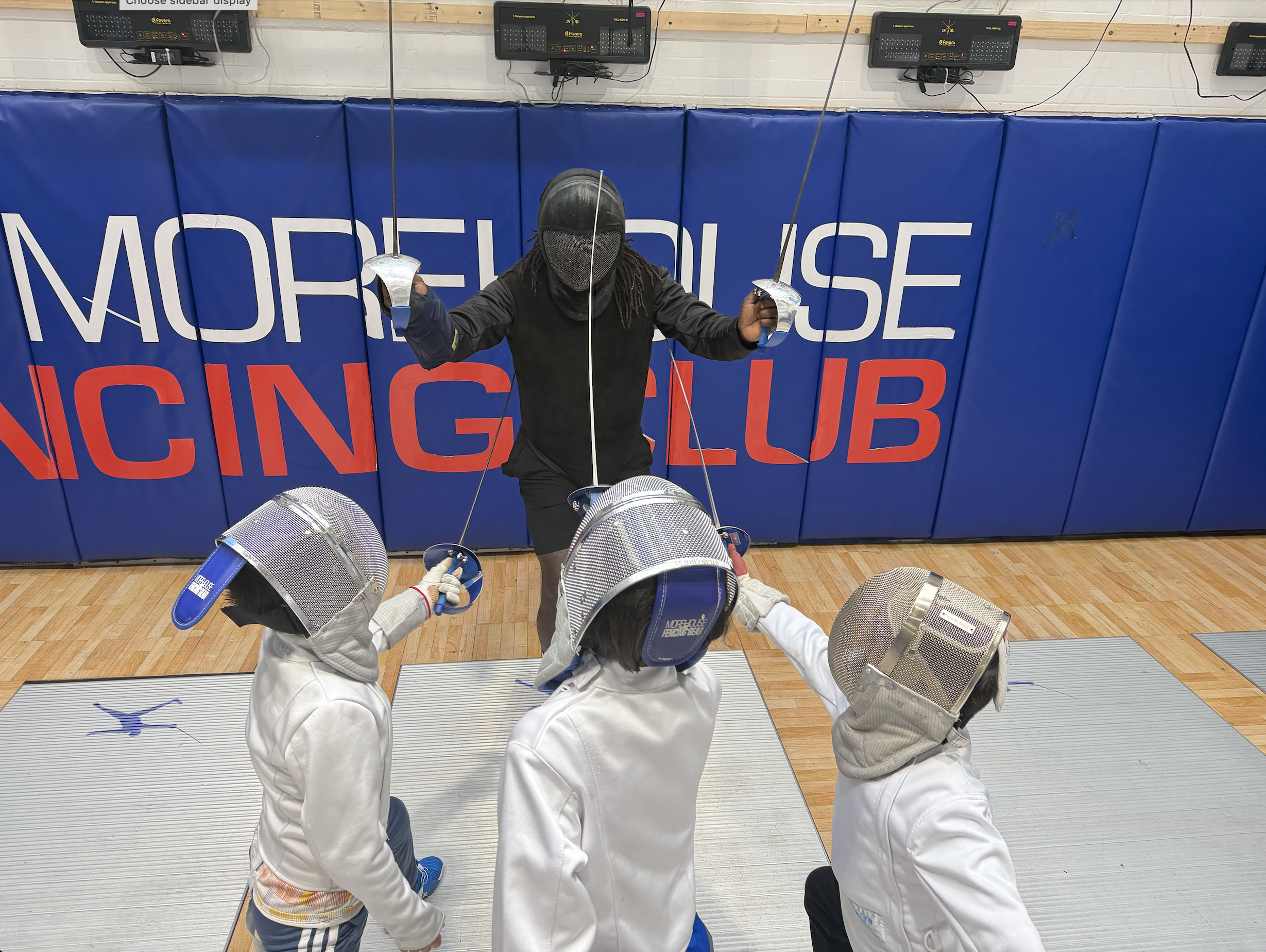 TMFC Midtown East fencing club — coach with three students at 235 East 49th Street