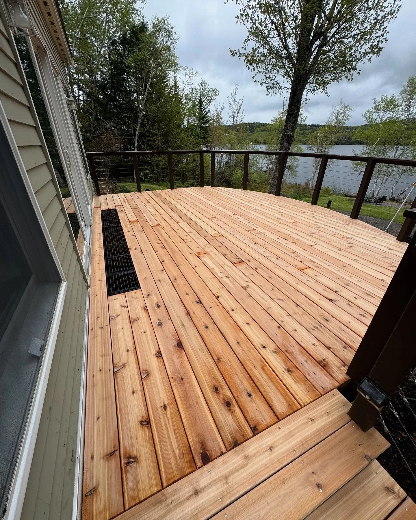 Ready for summer 🌅 This existing deck was jacked, leveled, and updated with western red cedar and a new grate.

Rangeley, Maine
