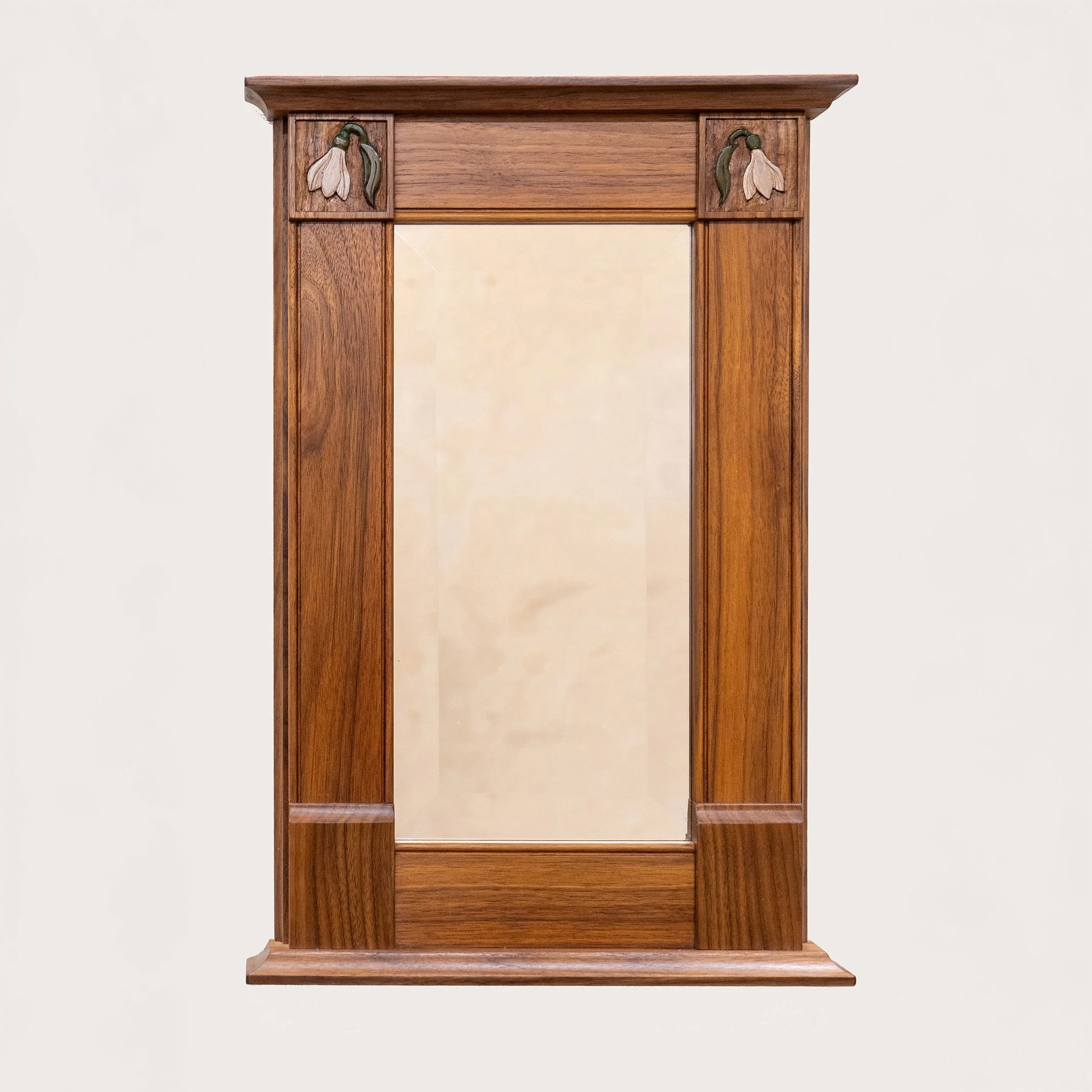 Walnut mirror frame with snowdrop corner carvings