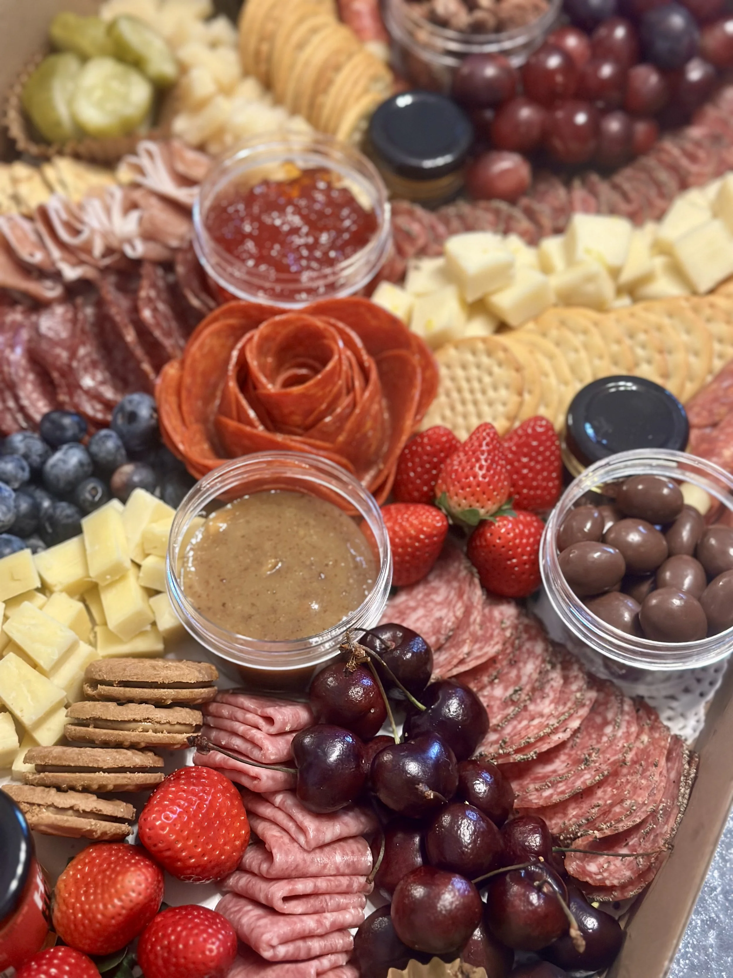 Close-up with Meat, Cheeses, Fruits, and Sauces